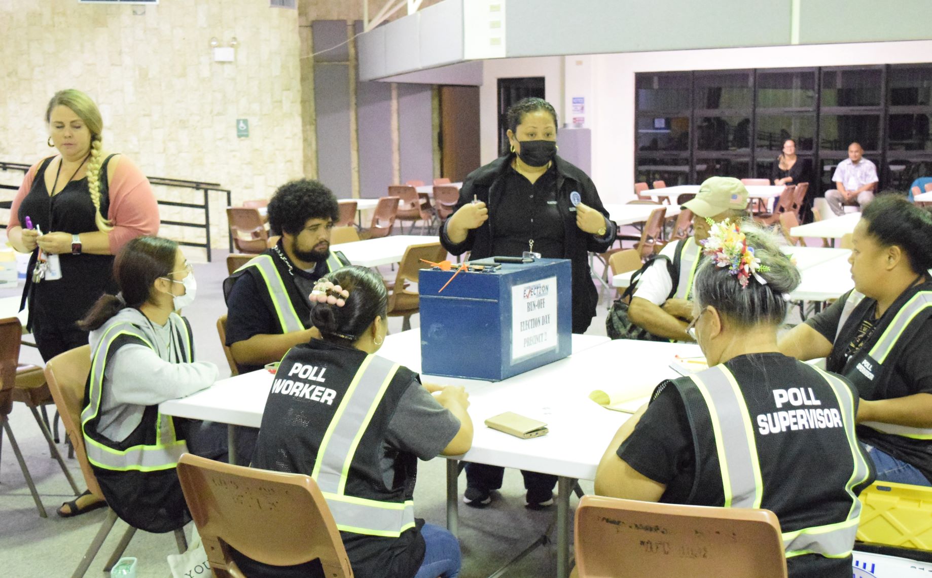 Commonwealth Election Commission Executive Director Kayla Igitol talks to poll workers prior to the tabulation of the runoff election ballots on Nov. 25, 2022 at the multi-purpose center in Susupe.