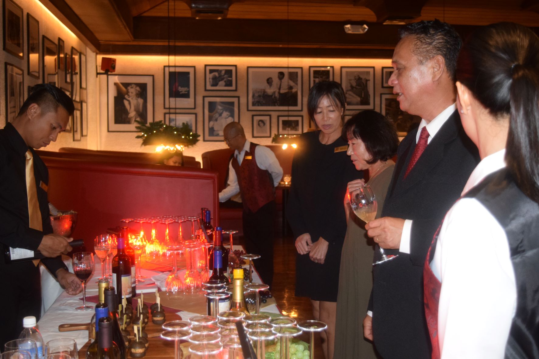 Aqua Resort Club Food and Beverage Manager Neil Metran, 2nd right, speaks to guests during the Aniti wine tasting event to mark Kevin's fifth anniversary at Aqua Resort Club on Thursday.