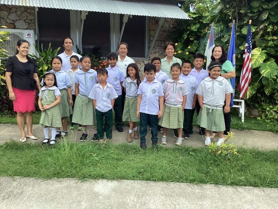 Green Meadow School students who participated in the grades K-2 category of the Primary Grade Forensic Conference pose for a photo with their teachers and school officials.