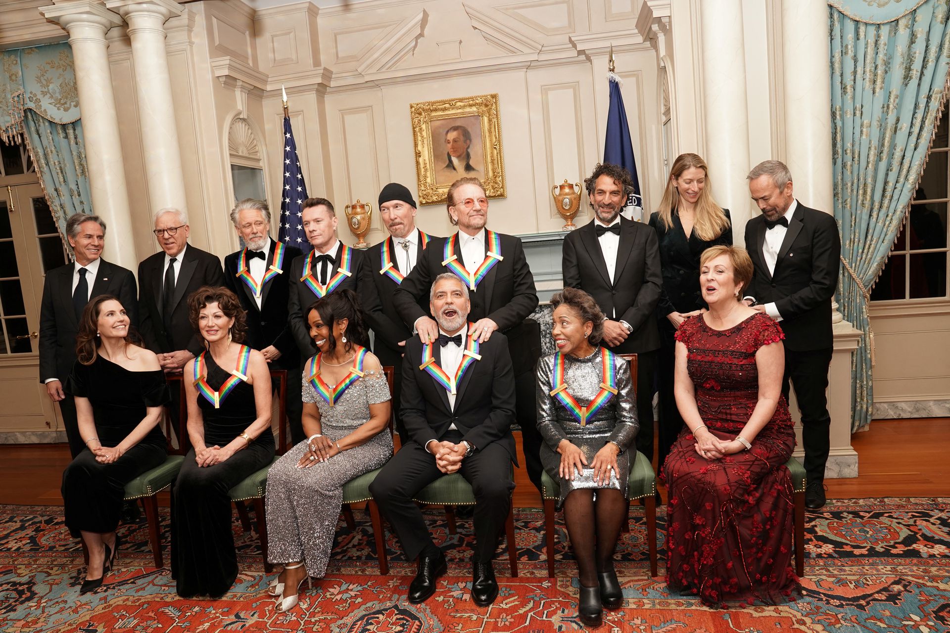 Kennedy Center honorees U2’s Bono and actor George Clooney laugh during a group photo during the reception for Kennedy Center honorees ahead of the official gala at the State Department in Washington, D.C., Dec. 3, 2022.