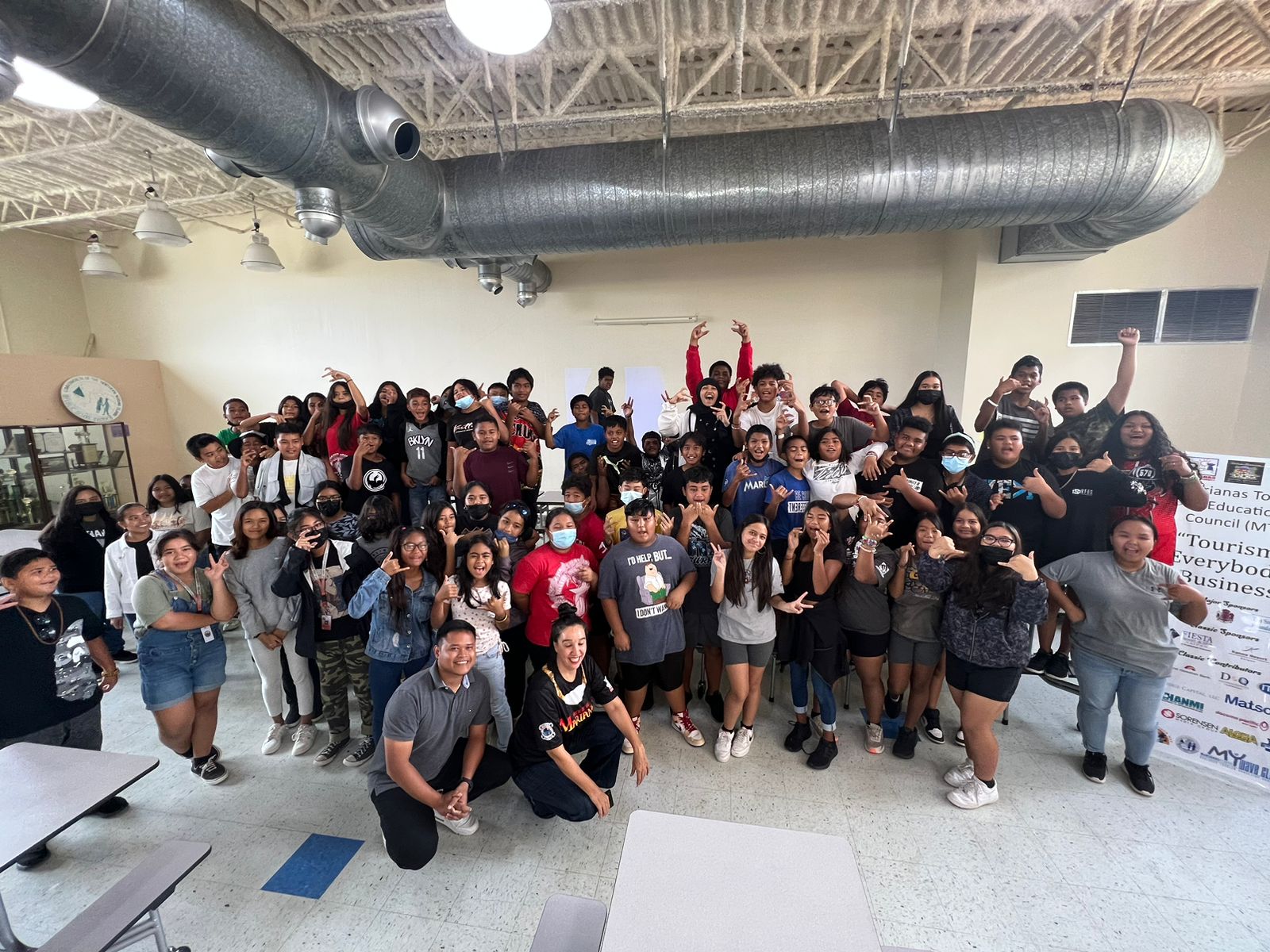 Marianas Visitors Authority Community Projects Specialist Jack Aranda, front left, and Marianas Tourism Education Council Board Member Catherine Perry, front right, share about the Marianas tourism industry with 7th graders at Chacha Oceanview Middle School on Dec. 14, 2022, in Kagman, Saipan.