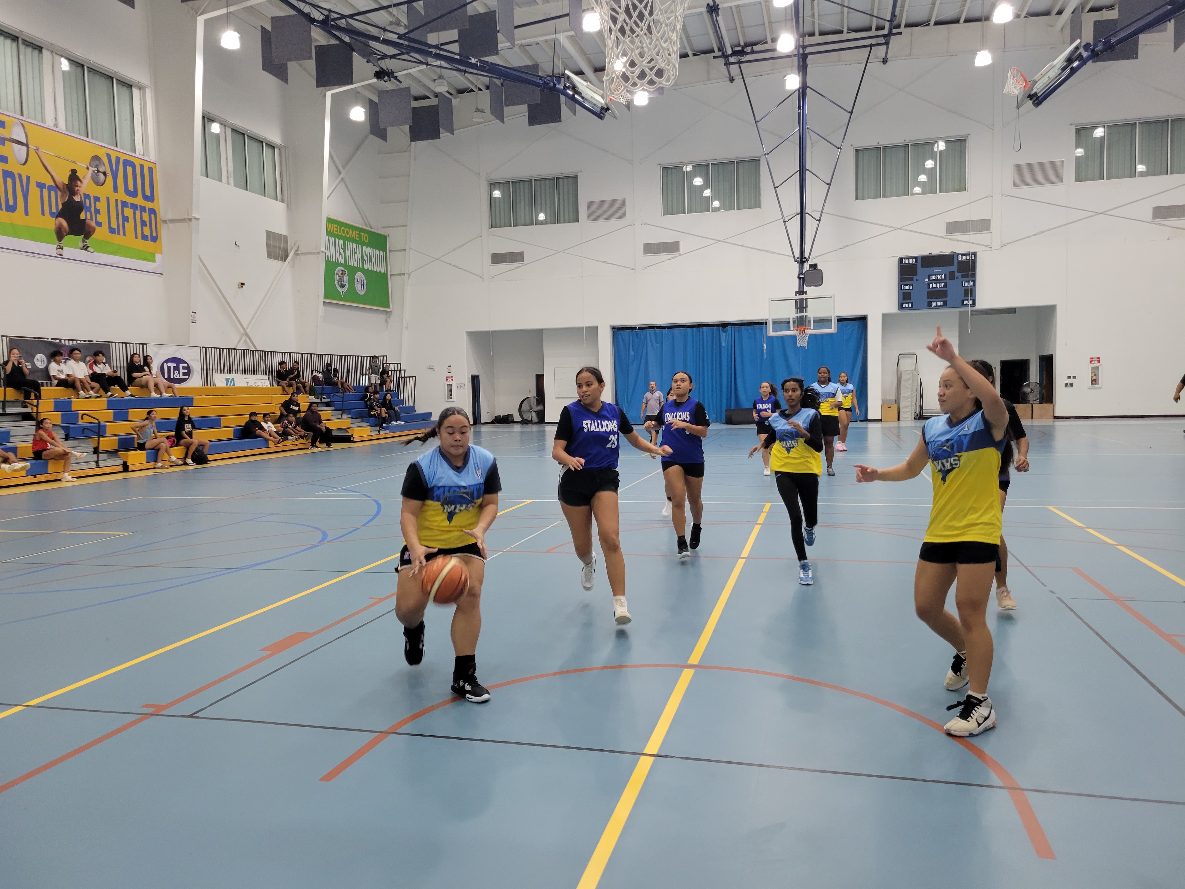 An MHS player drives toward the hoop as the other hoopsters look on during a girls high school division game of the IT&E Interscholastic Basketball League Saturday at the MHS gym.