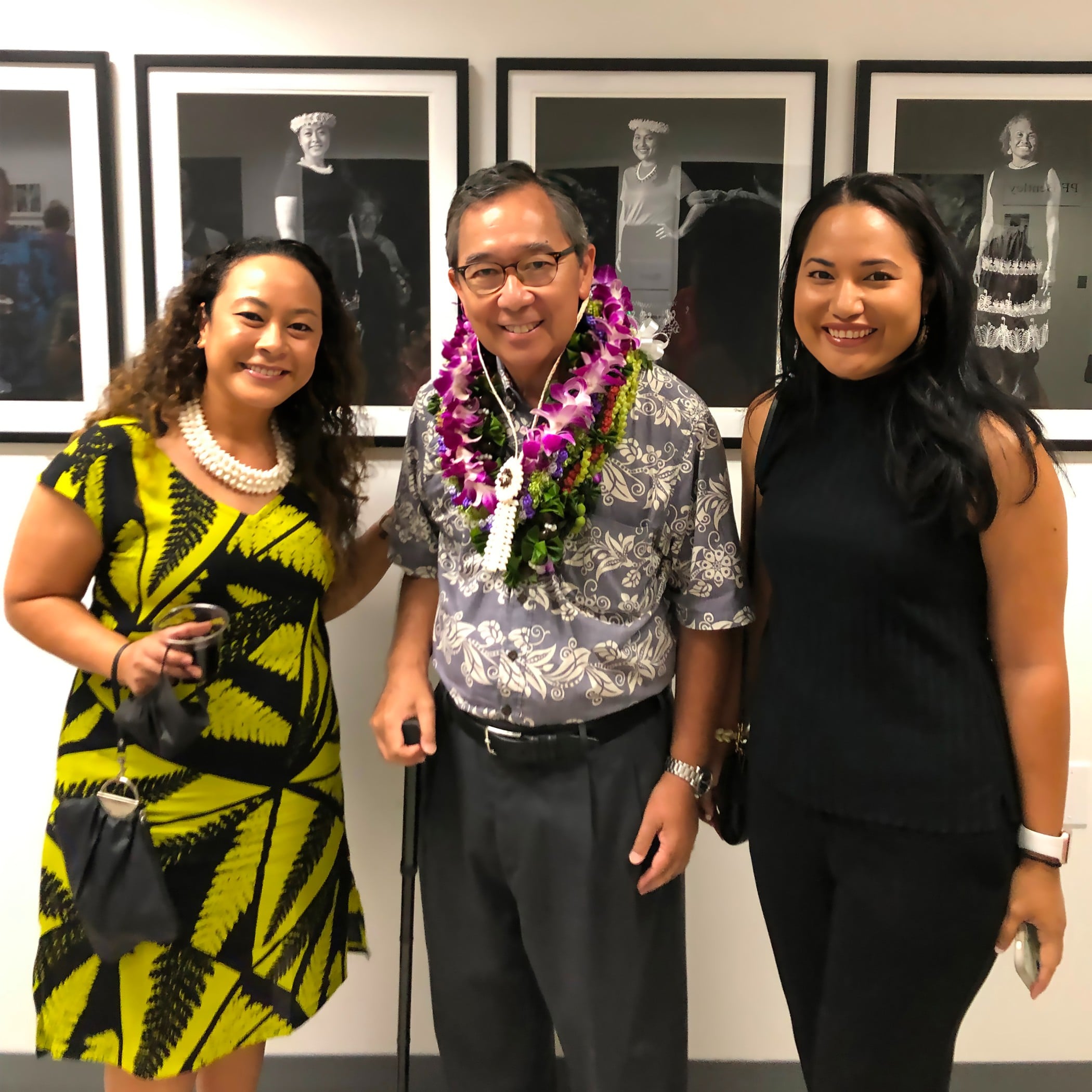 Photographer Floyd K. Takeuchi at the opening of his exhibition in Honolulu, "The Micronesians," in early September with Marshallese attorney Arsima Muller, left, and Marshall Islands Consul General Isabela Silk — both of whom are featured in the photographs in the back.