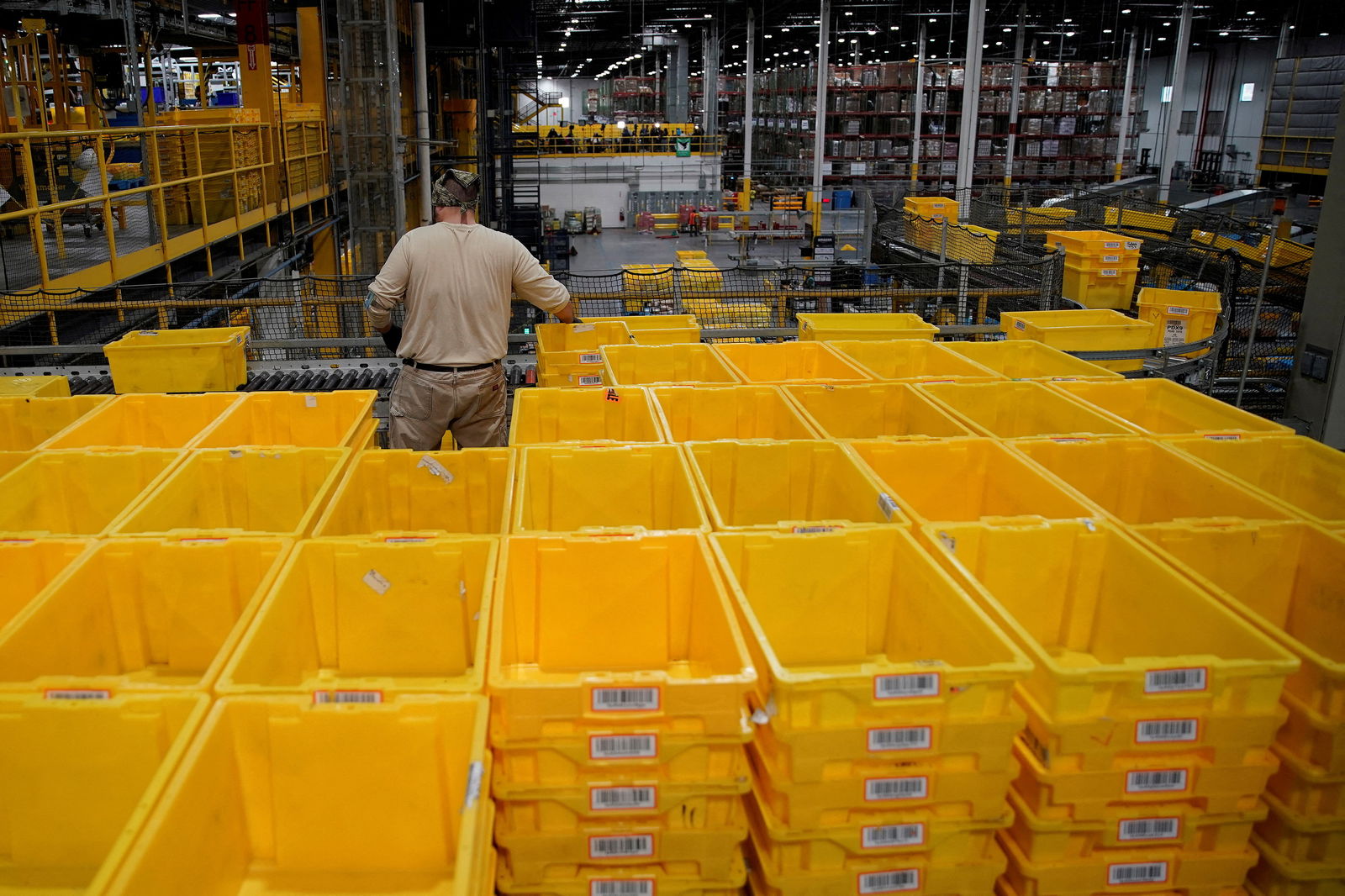 A worker organizes empty bins during Cyber Monday at the Amazon fulfillment center in Robbinsville Township in New Jersey, Nov. 28, 2022.
