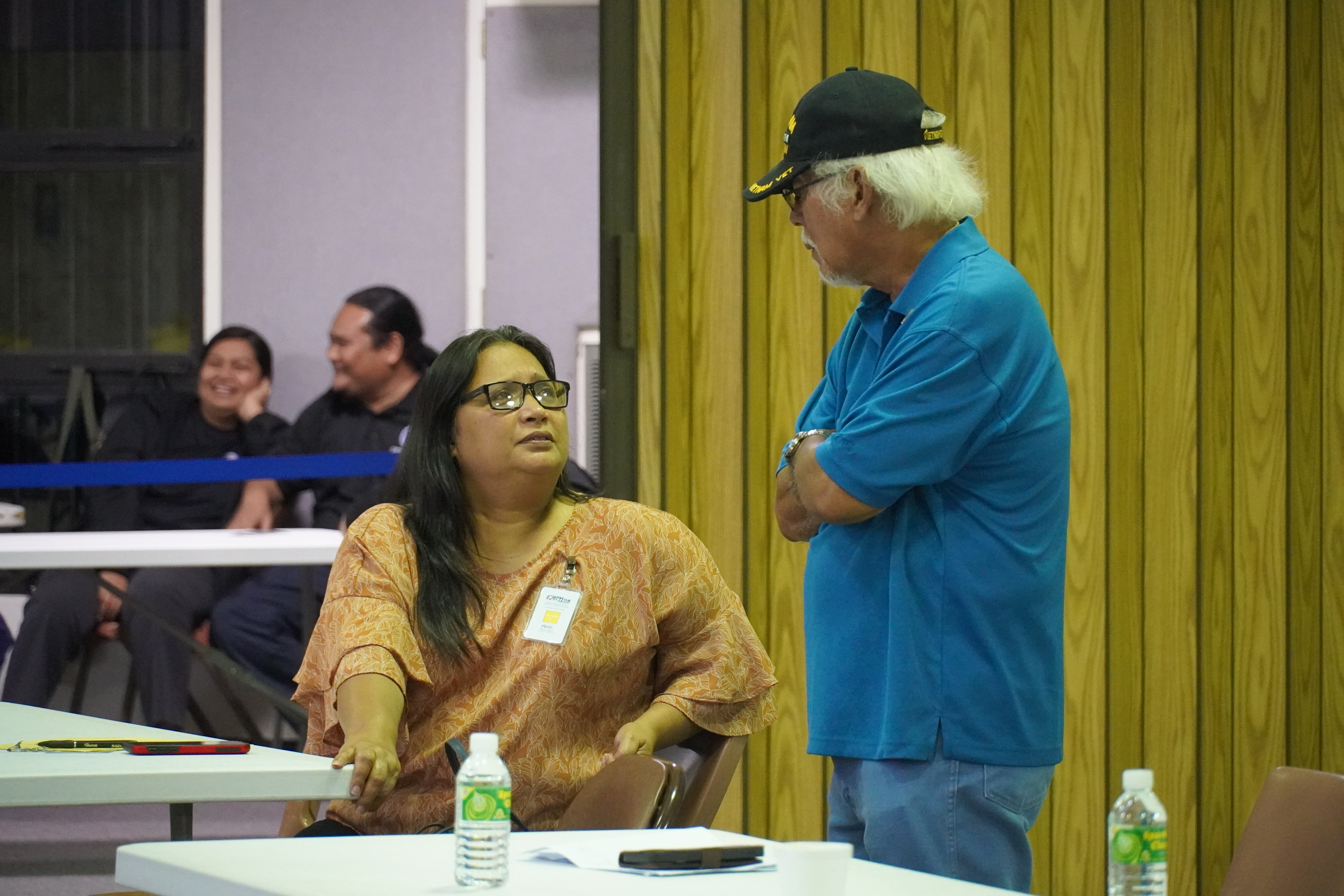 NMI Republican Party President Candace Celis and Independent poll observer Pete P. Reyes converse while ballots are tabulated.
