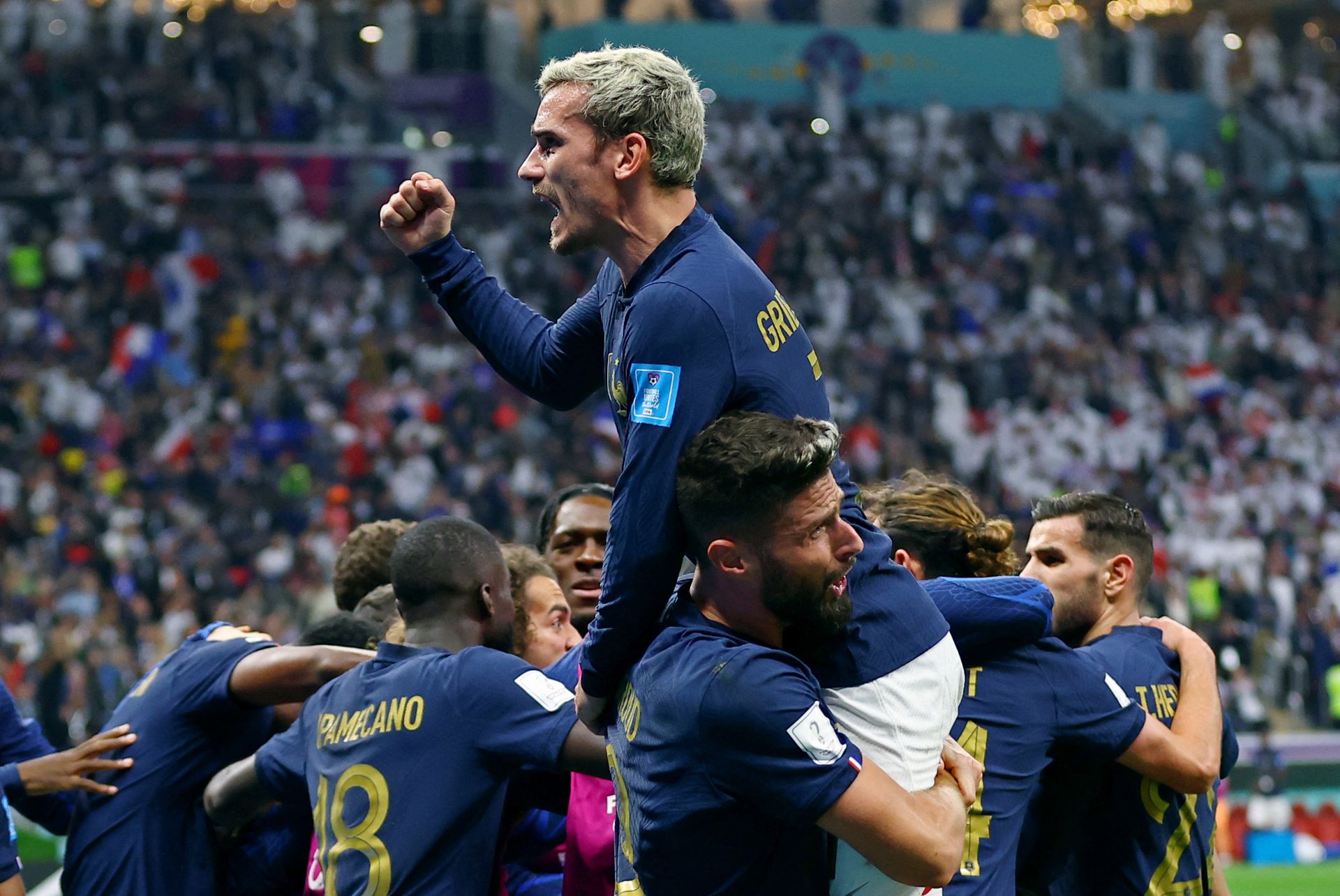 France's Olivier Giroud celebrates scoring their second goal against England with Antoine Griezmann and teammates at Al Bayt Stadium in Al Khor, Qatar on Dec. 10, 2022