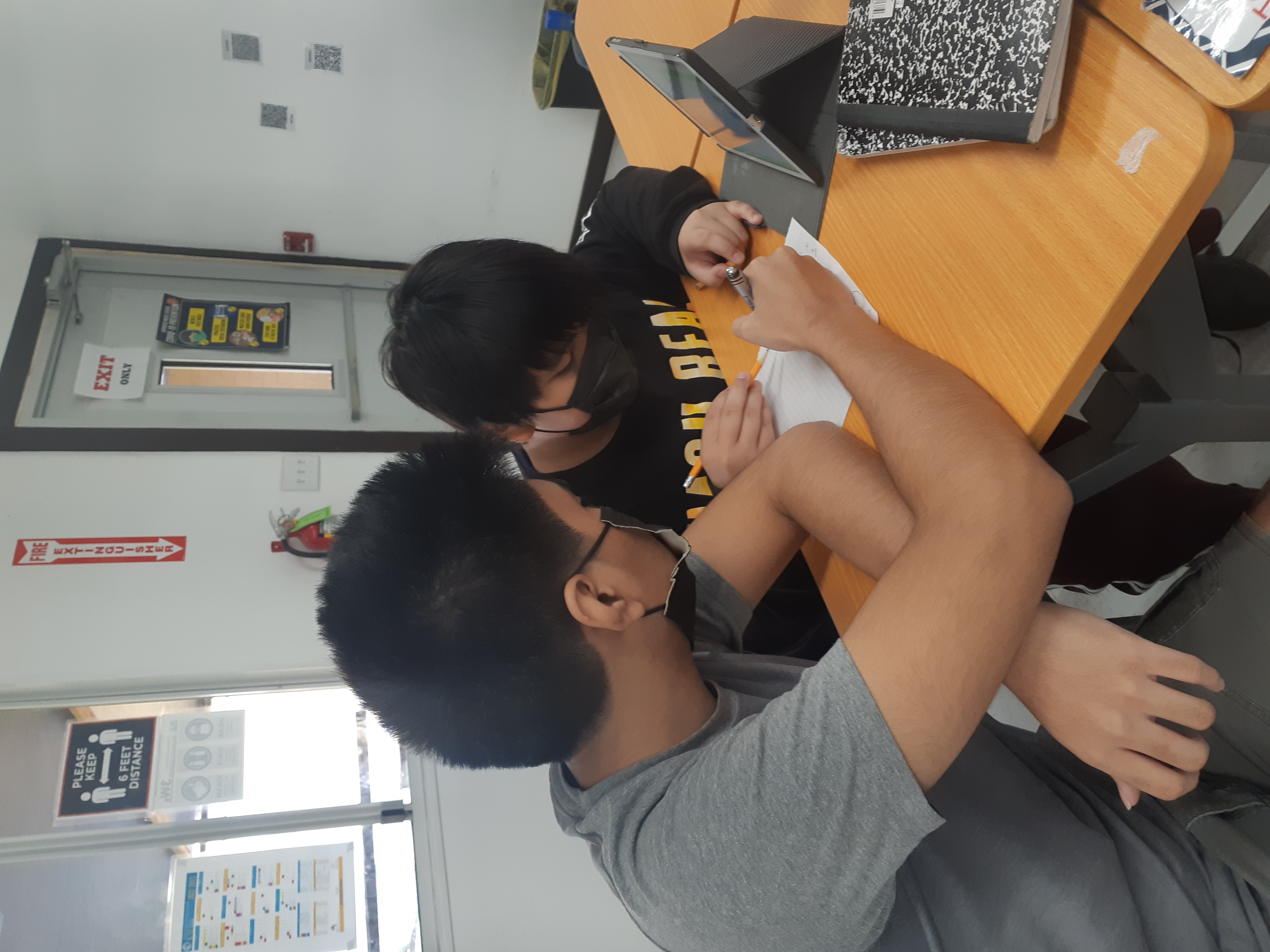  Tutor Edriel Javier with a student.