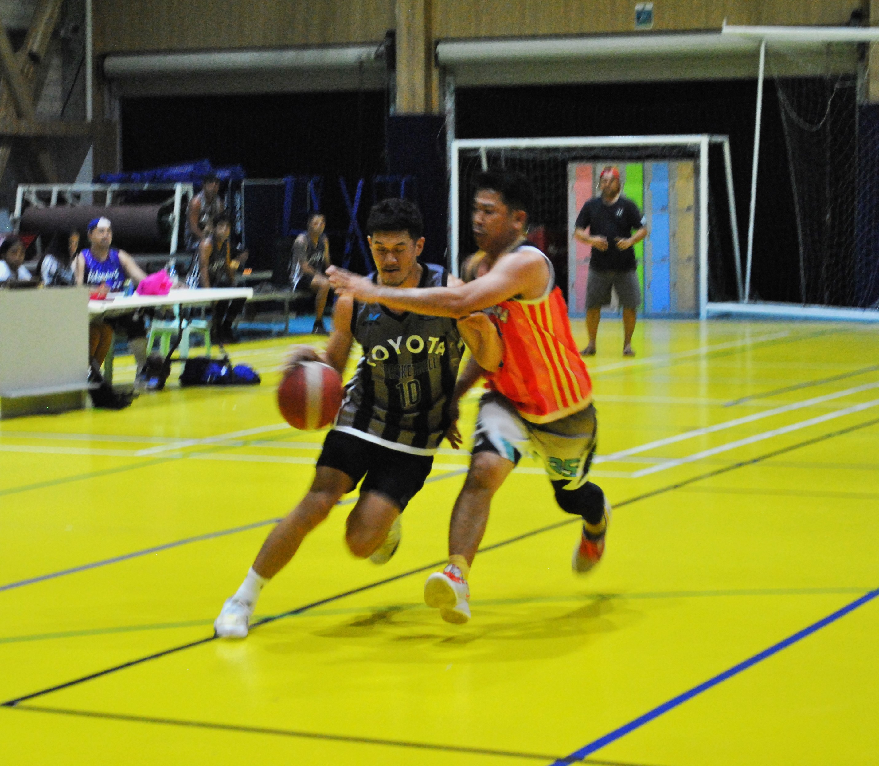 AK Toyota's Shane Deleon Guerrero attempts to drive past an Eats Easy defender during a 2022 IT&E MIBL Fantasy Draft Tournament game Saturday at the ACS gym.