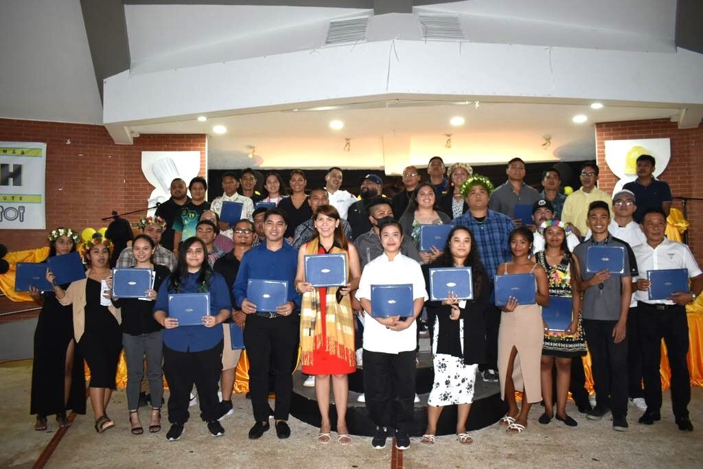 The Northern Marianas Technical Institute graduates, instructors, administrators, and key officials pose for a photo at Garapan Central Park on Nov. 22, 2022.