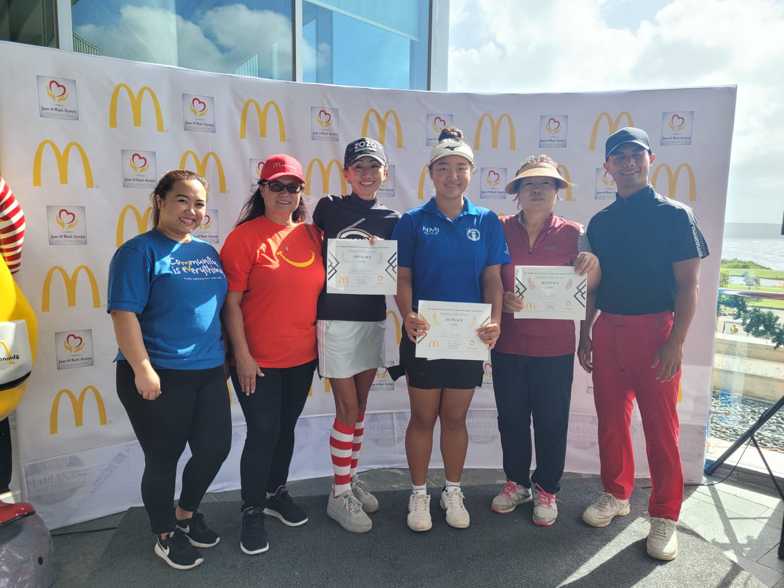 Zhimin Jin, third right, Yuko Togawa, third left, Joen Me Ae, second right, with McDonald's Saipan owner/operator Marcia Ayuyu, second left, executive assistant to the president Natalie Mable Ayuyu-Glenn, left, and McDonald's Guam & Saipan vice president Joe Ayuyu Jr., right, during the awards banquet for McDonald's 2nd Annual Golf Classic at LaoLao Bay Golf & Resort on Saturday.