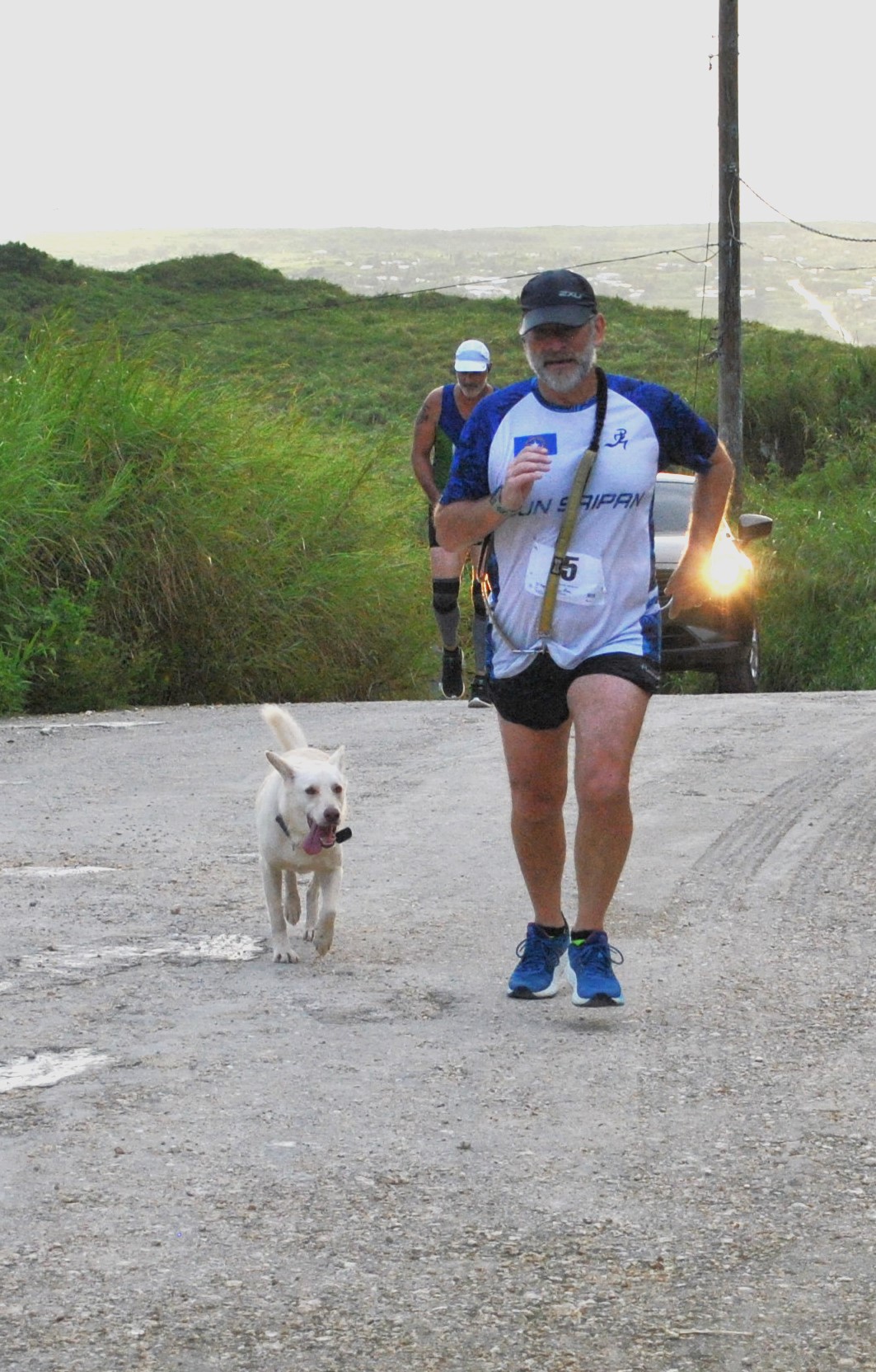 Dr. Ron Snyder and his dog Gilligan push to the finish line of the Mt. Tapochao Turkey Trot last month.