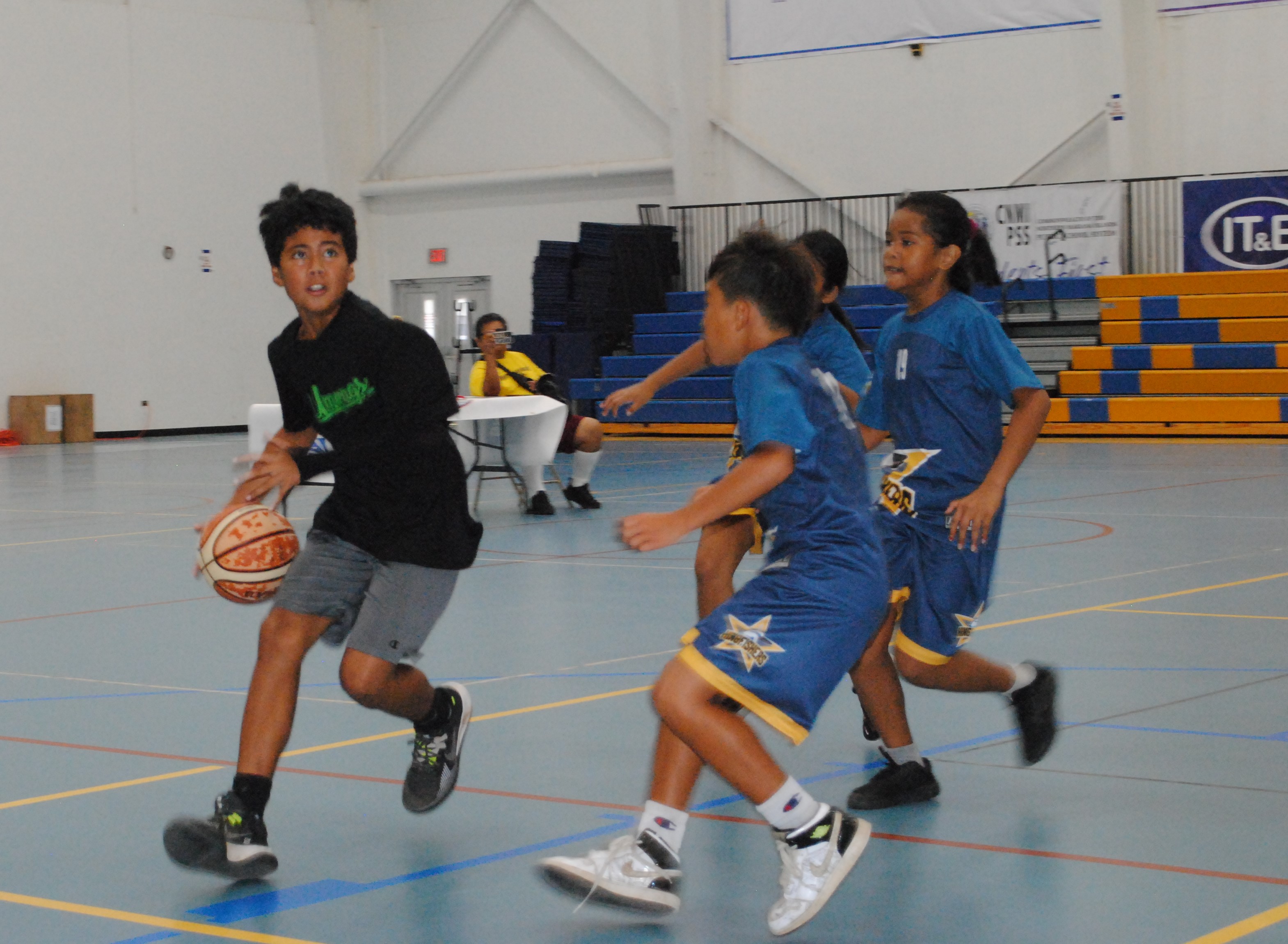 Koblerville's Logan Daniel drives toward the hoop as three WSR defenders close in during the co-ed elementary school division championship game of the IT&E Interscholastic Basketball League  on Saturday at the MHS gym.