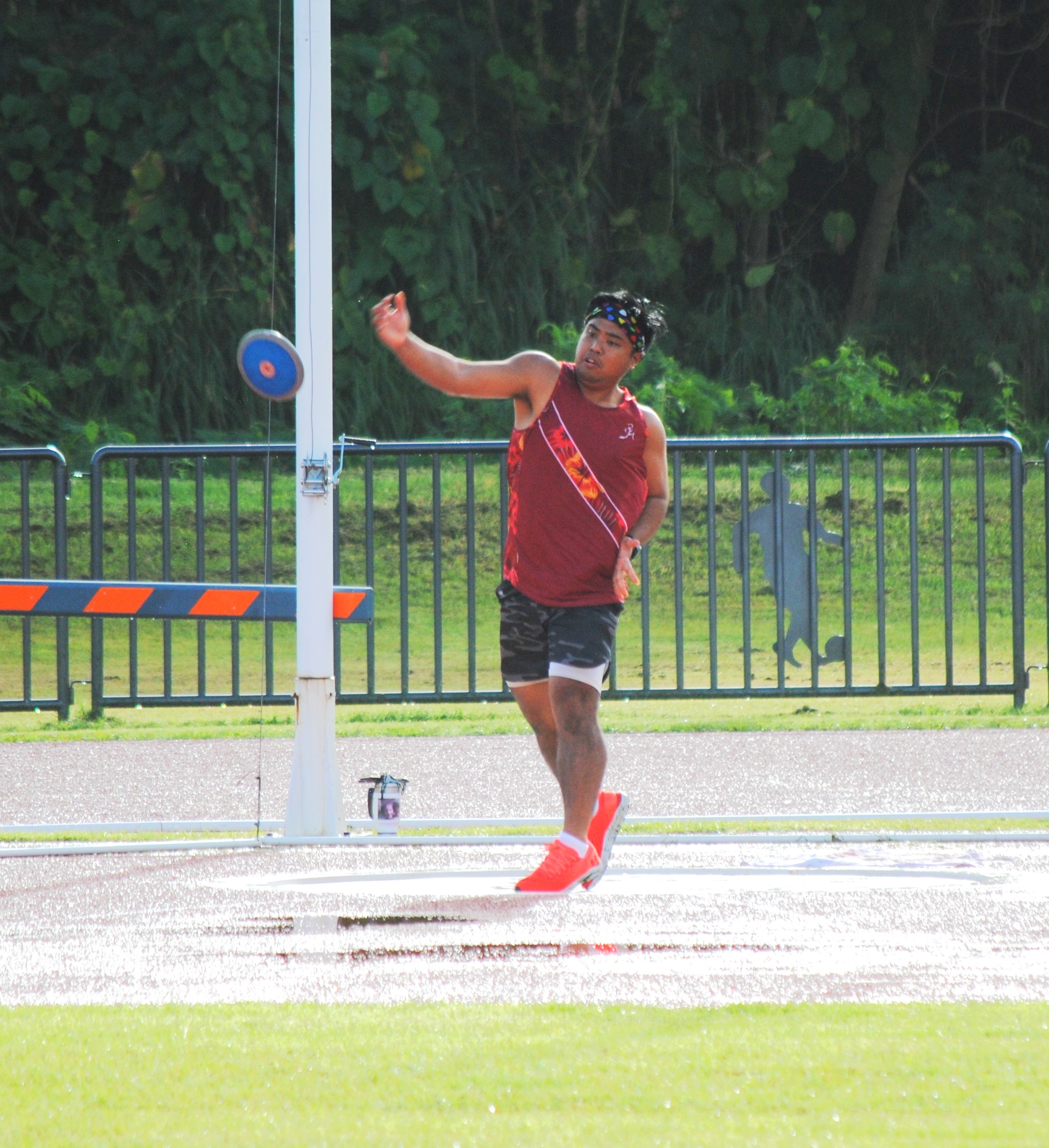 Simon Necesito in action in the discus throw event.