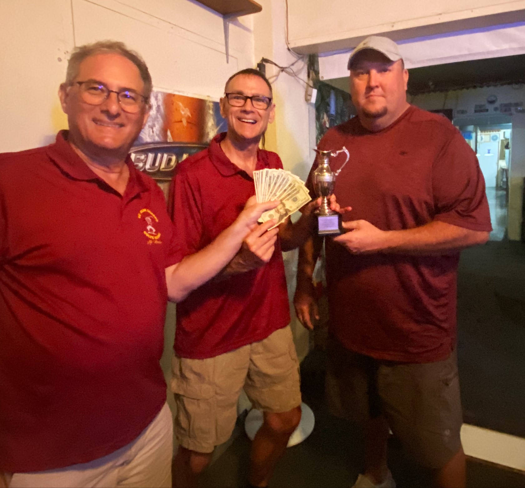 Club Secretary Richard "Caddy Dipper" Miller awards Fossil the prize money while last year's champion Supersandy looks on.