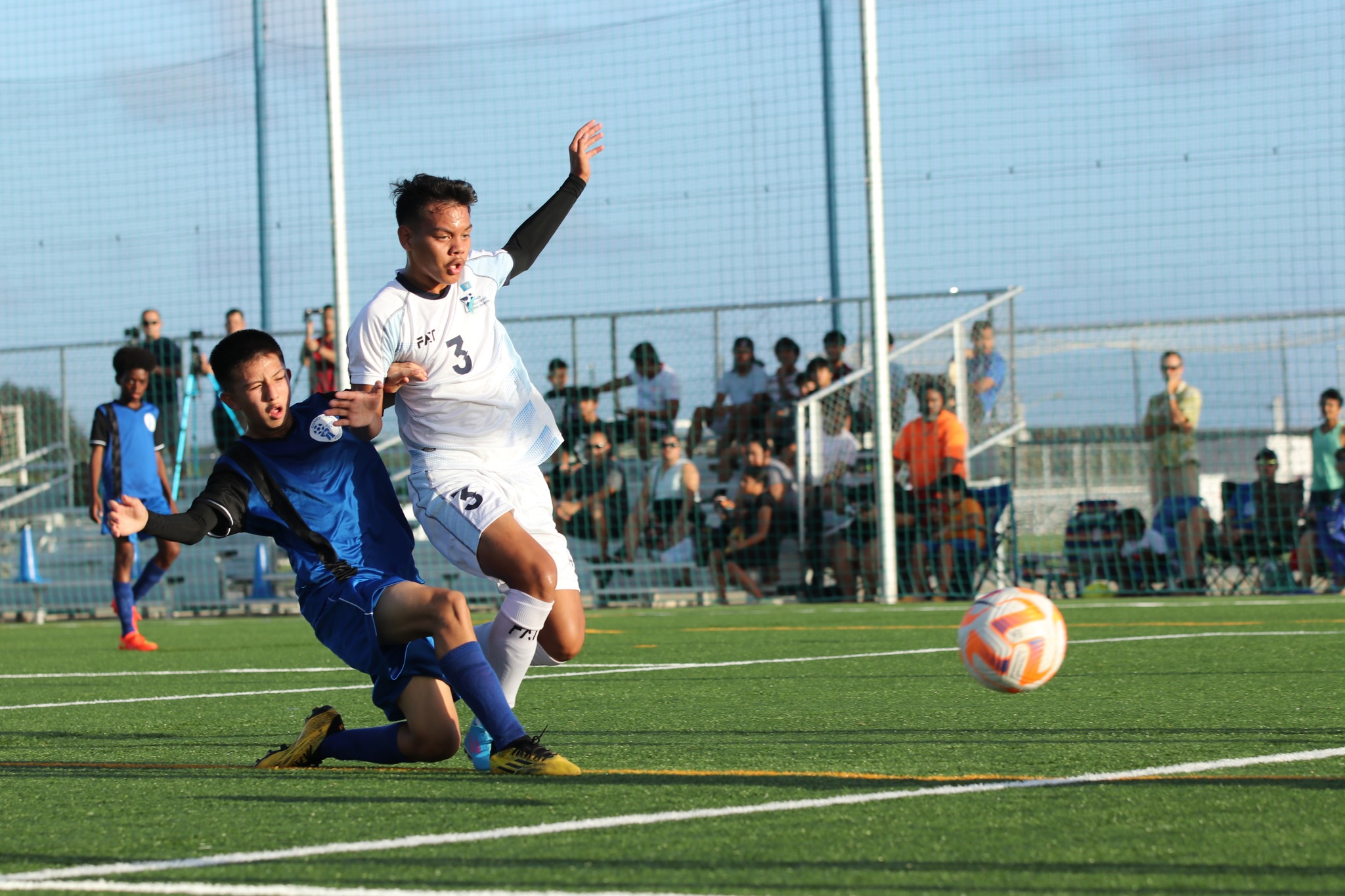 The NMI’s Aiden Camacho attempts the interception as a Guam player takes the shot during a training match Monday at the NMI Soccer Training Center in Koblerville.
