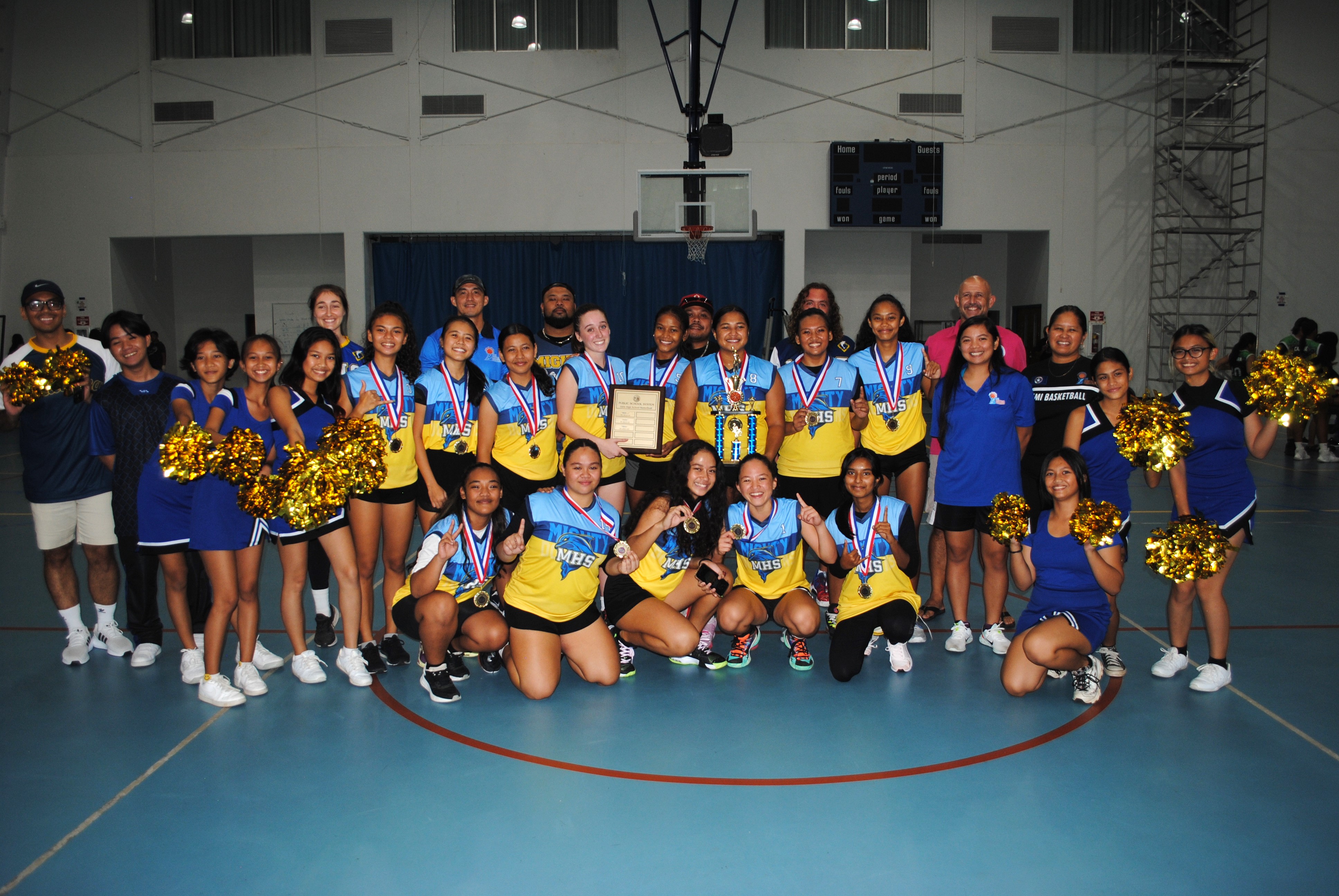The MHS varsity team members  and cheerleaders pose for a photo after winning the girls high school division title of the IT&E Interscholastic Basketball League on Saturday at MHS gym.