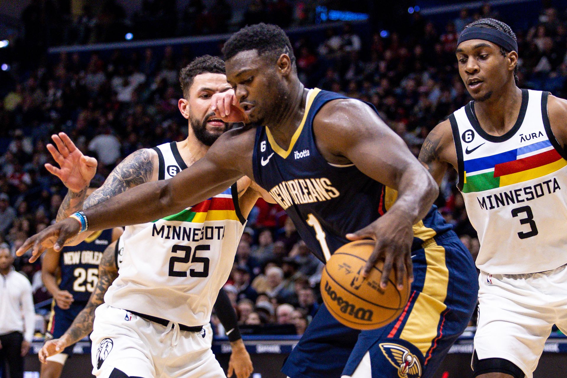 New Orleans Pelicans forward Zion Williamson (1) dribbles against Minnesota Timberwolves guard Austin Rivers (25) and forward Jaden McDaniels (3) during the first half at Smoothie King Center in New Orleans, Louisiana, Dec. 28, 2022.