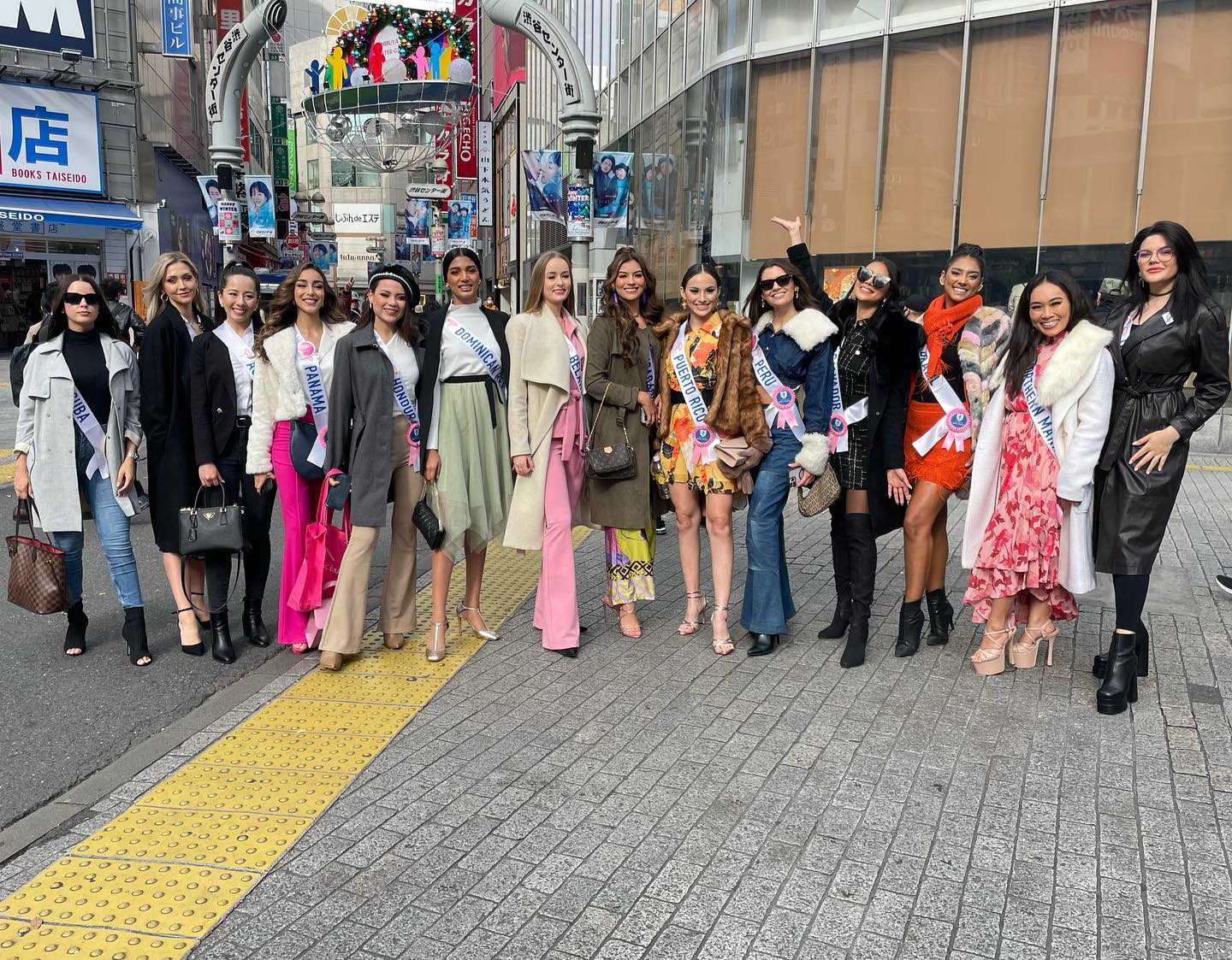 Miss Marianas  Savannah Lyn Relox Delos Santos, second right, poses for a photo at the famous Shibuya Crossing, along with other pageant contestants.