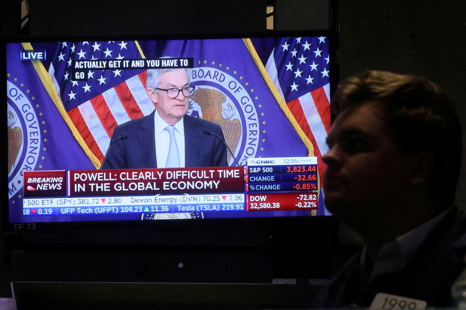A screen displays Federal Reserve Chair Jerome Powell speaking as a trader works on the floor of the New York Stock Exchange in New York City on Nov. 2, 2022.