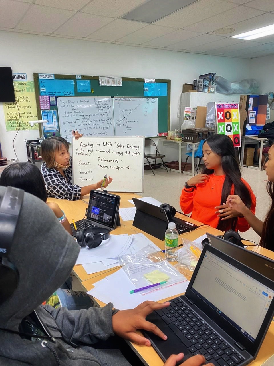 A tutor engages with her students.