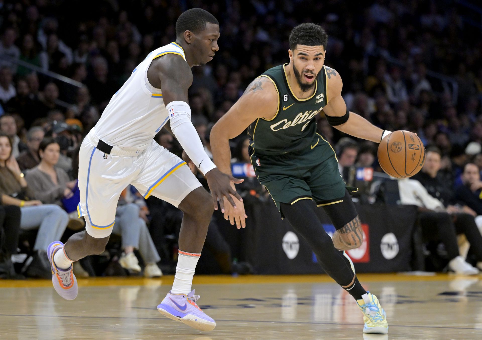 Boston Celtics forward Jayson Tatum (0) moves past Los Angeles Lakers guard Kendrick Nunn (12) in the first half at Crypto.com Arena in Los Angeles, California,  Dec. 13, 2022.