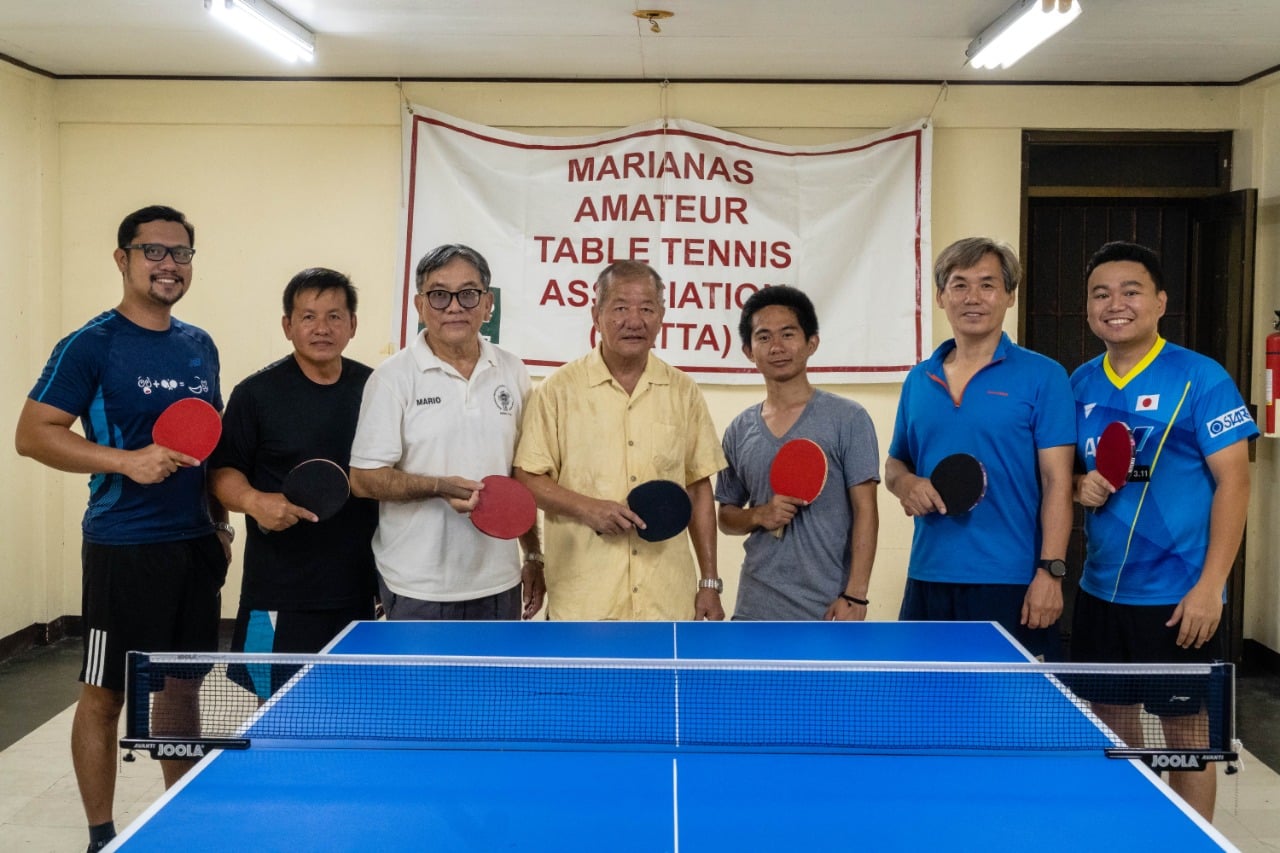 Budhi Gurung, center, poses for a photo with fellow table tennis enthusiasts on Saipan for a farewell game on Tuesday last week.