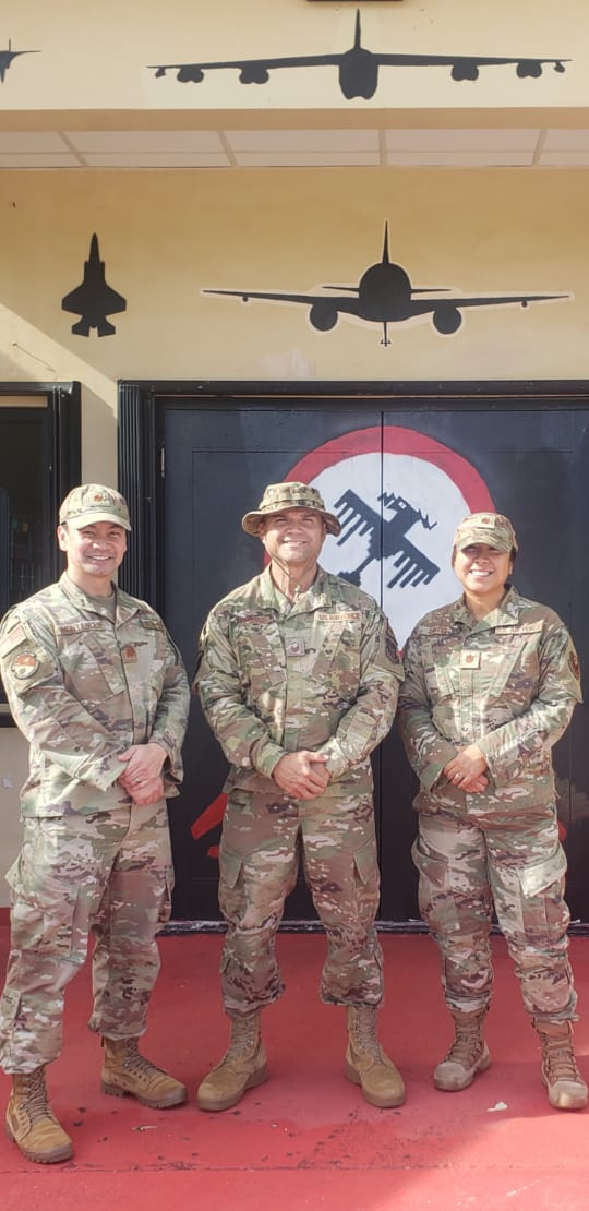 U.S. Air Force Master Sgt. Stanley Iakopo, center, with U.S. Air Force Special Operations School course directors Maj. Darielle Santos, right, and Maj. Carlos Montances, left, at the USAFSOS in Florida.