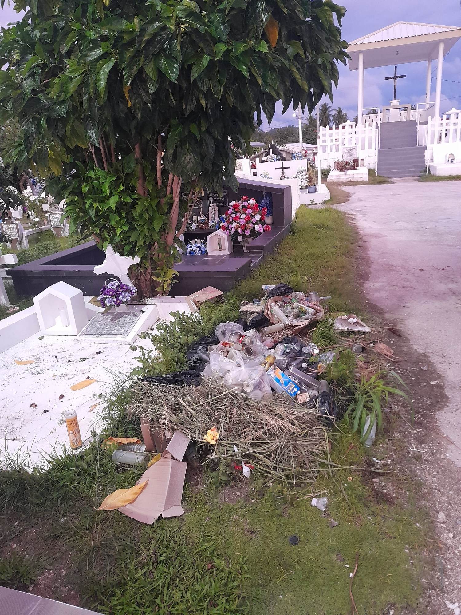 Trash is seen near a grave at the Chalan Kanoa cemetery.