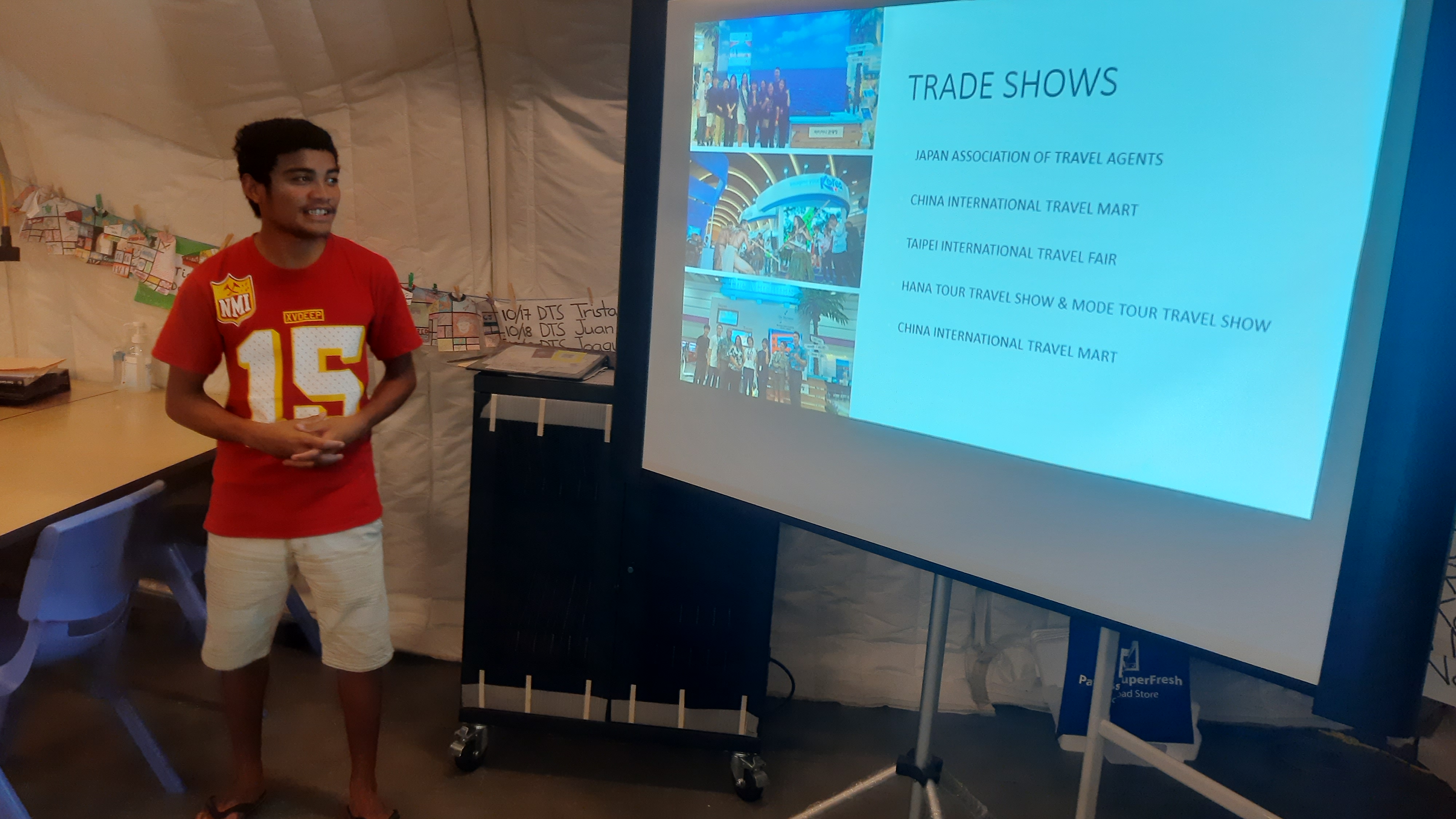 Student Xavier Sumor of Da’ok Academy assists with the tourism presentation made by Marianas Tourism Education Council and the Marianas Visitors Authority at the school on Dec. 6, 2022, in Koblerville, Saipan.