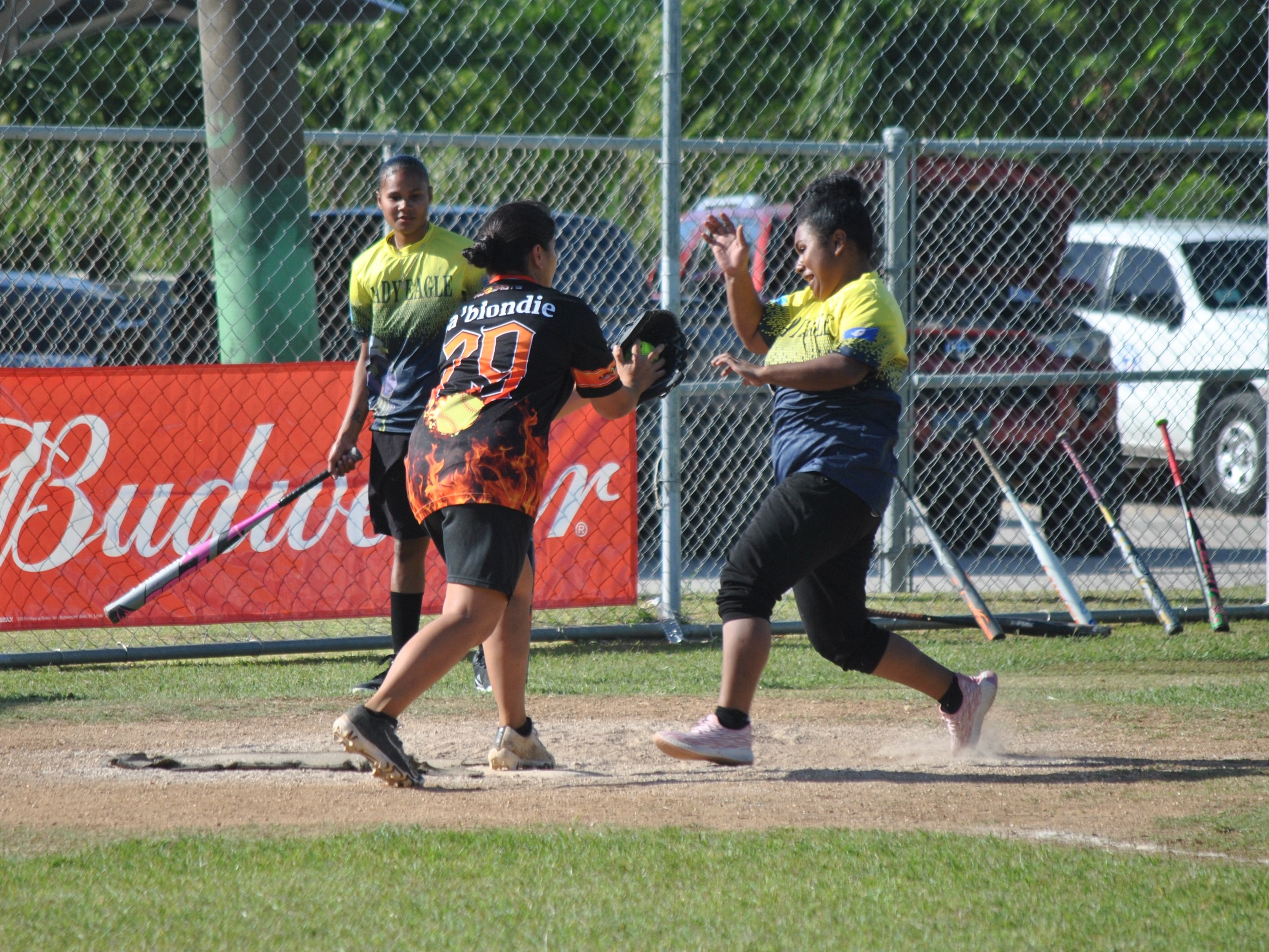 Hotshots catcher Janice Celis reaches to tag out a Lady Eagles runner at home during a semifinal game in the ladies division of the 2022 Budweiser Belau Amateur Softball League Sunday at the Dandan baseball field.