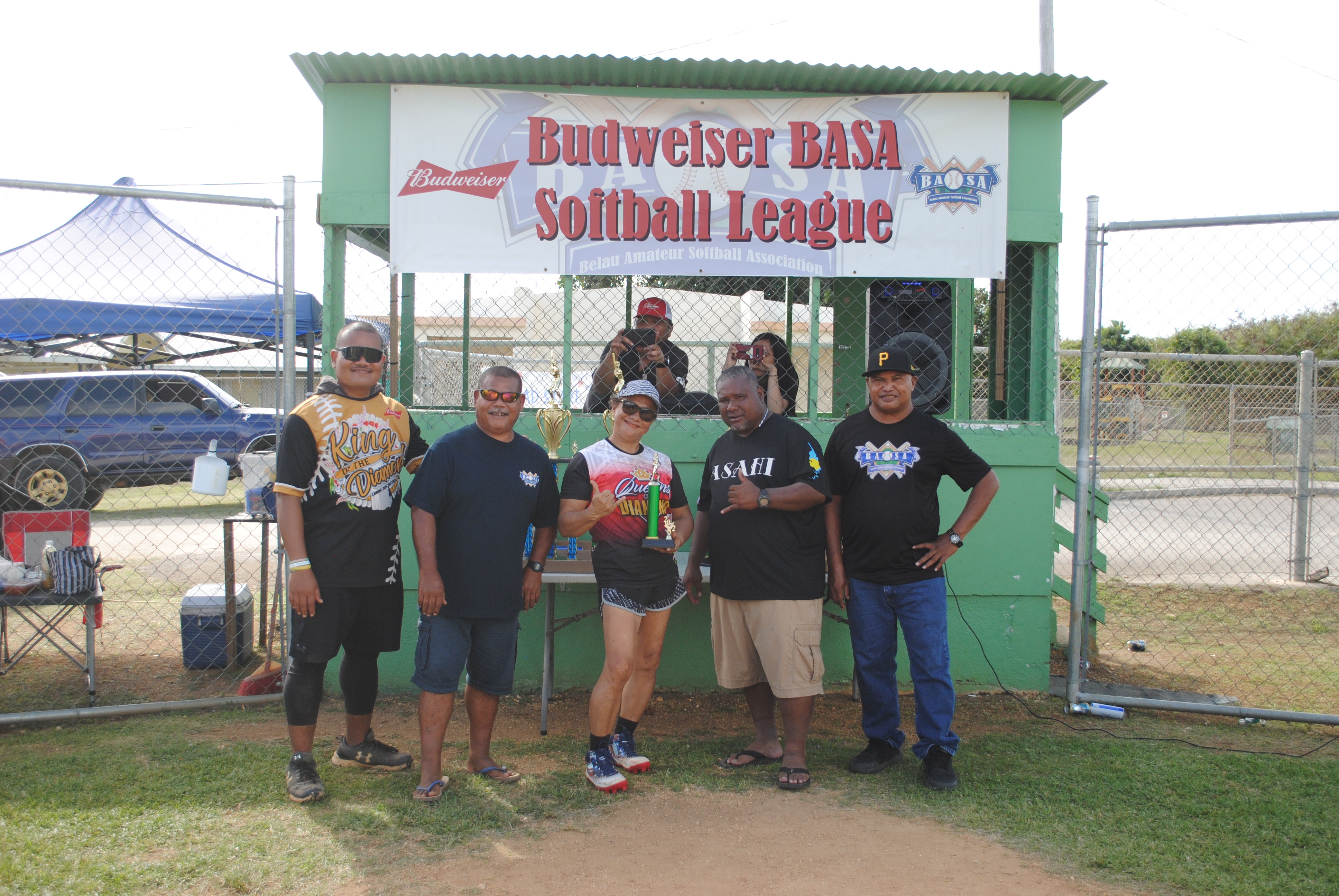 Bert Camacho, the women’s division championship MVP, poses with Belau Amateur Softball Association officials Byron Kaipat,   Leo Bobai, Hector Efraim and John Tutii during the awards ceremony Sunday at the Dandan baseball field