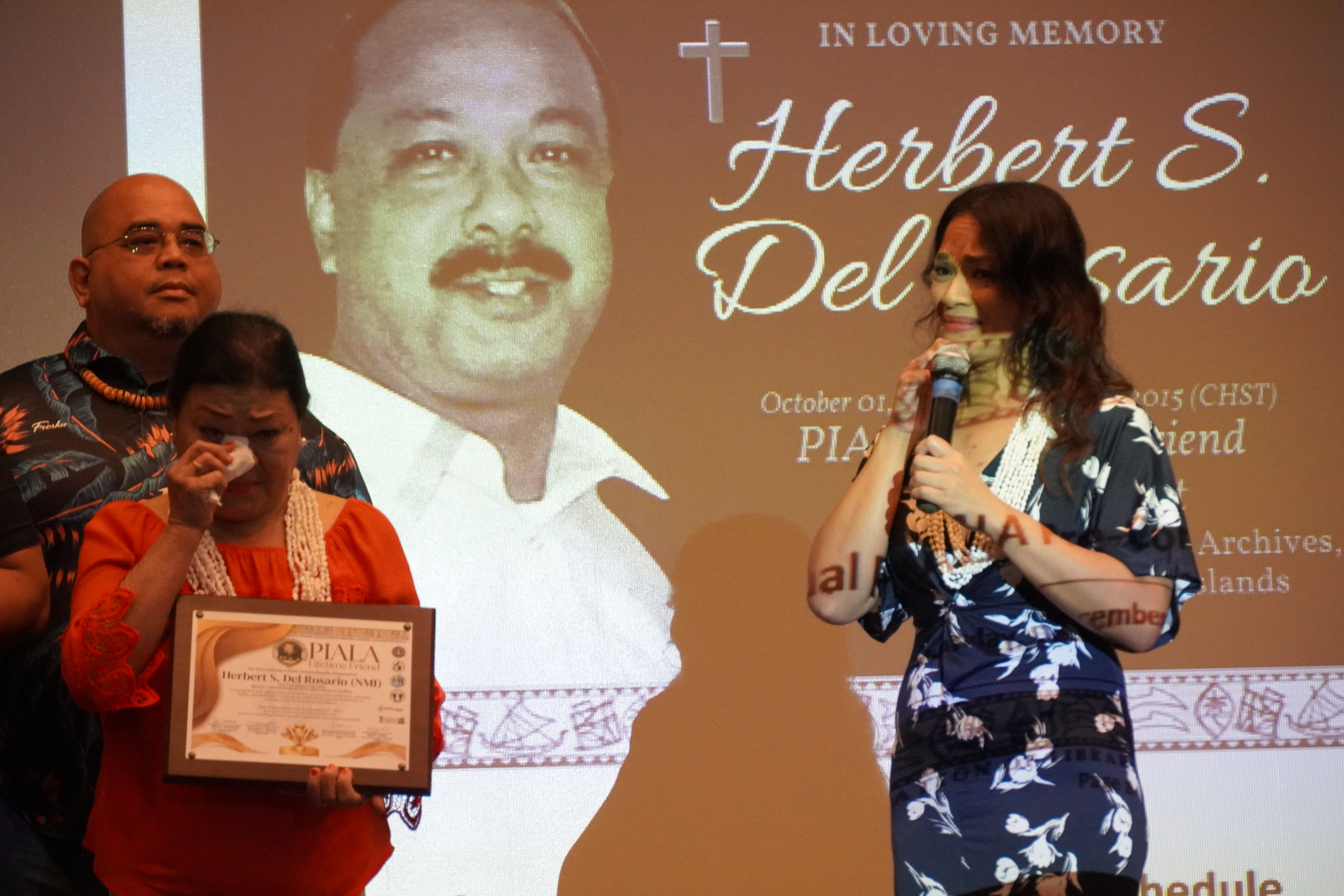 Tracy Del Rosario, daughter of the late CNMI archivist Herbert Del Rosario, and her mother Rose, are overwhelmed with emotion as they receive his posthumous award.