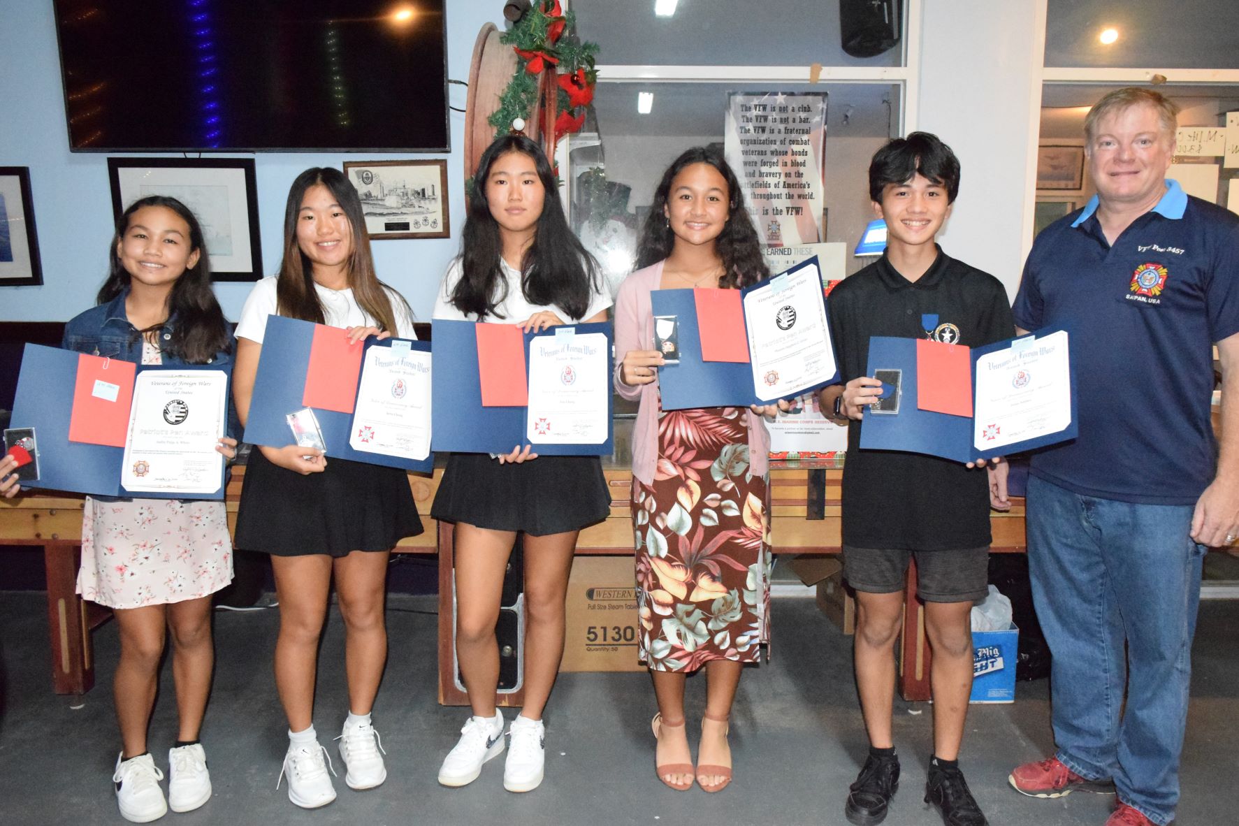 From left, Aubrey Page A. White, second place, Patriot's Pen; Serin Chung, second place, Voice of Democracy; Irin Chung, third place, Voice of Democracy; Phoenix Sapphire Gross, third place, Patriot’s Pen; Jesus T. Sablan, first place, Voice of Democracy; and VFW Post 3457 Commander Robert DeRocher.