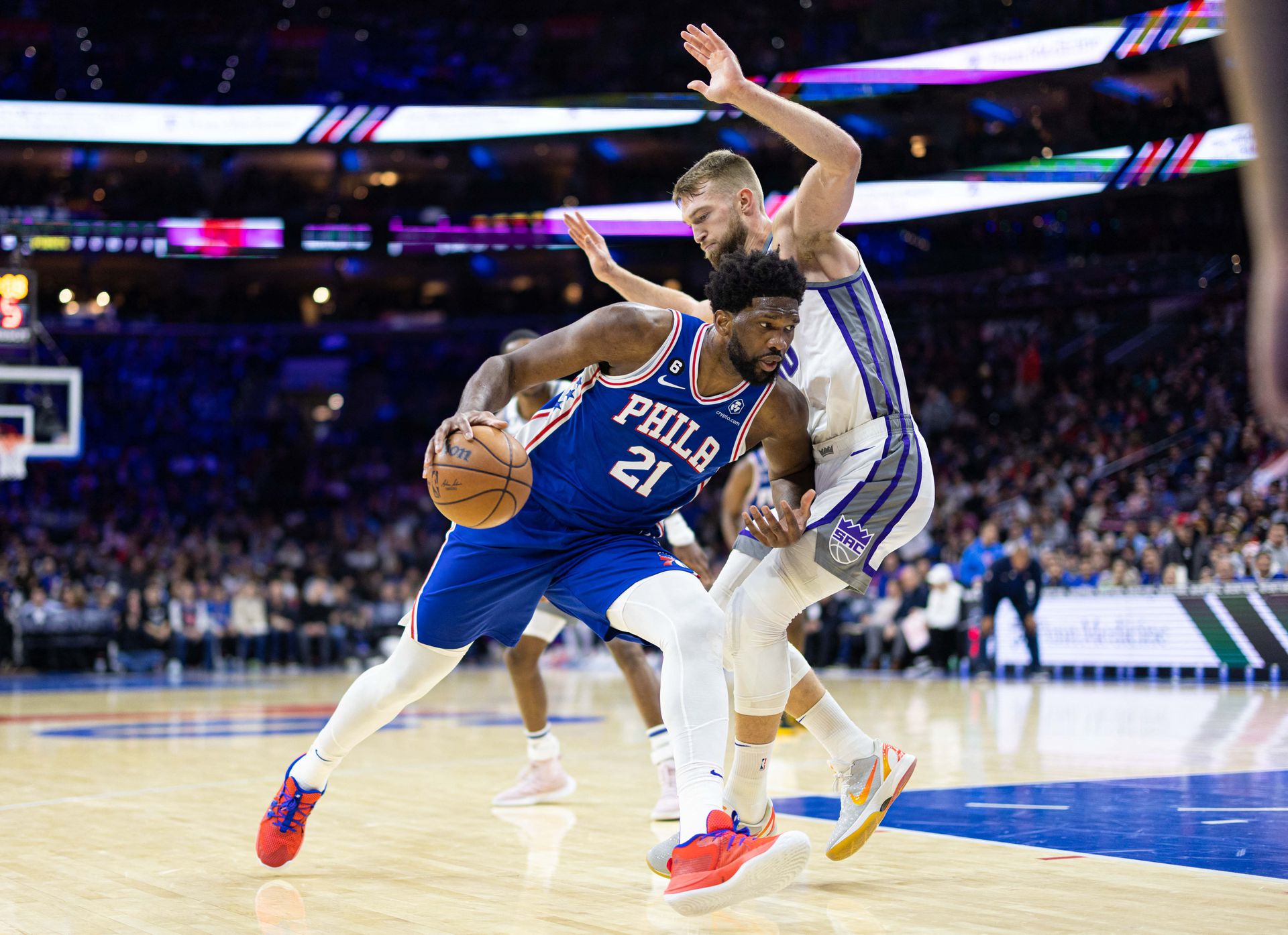 Philadelphia 76ers center Joel Embiid (21) drives against Sacramento Kings forward Domantas Sabonis (10) during the third quarter at Wells Fargo Center in Philadelphia, Pennsylvania, Dec. 13, 2022.