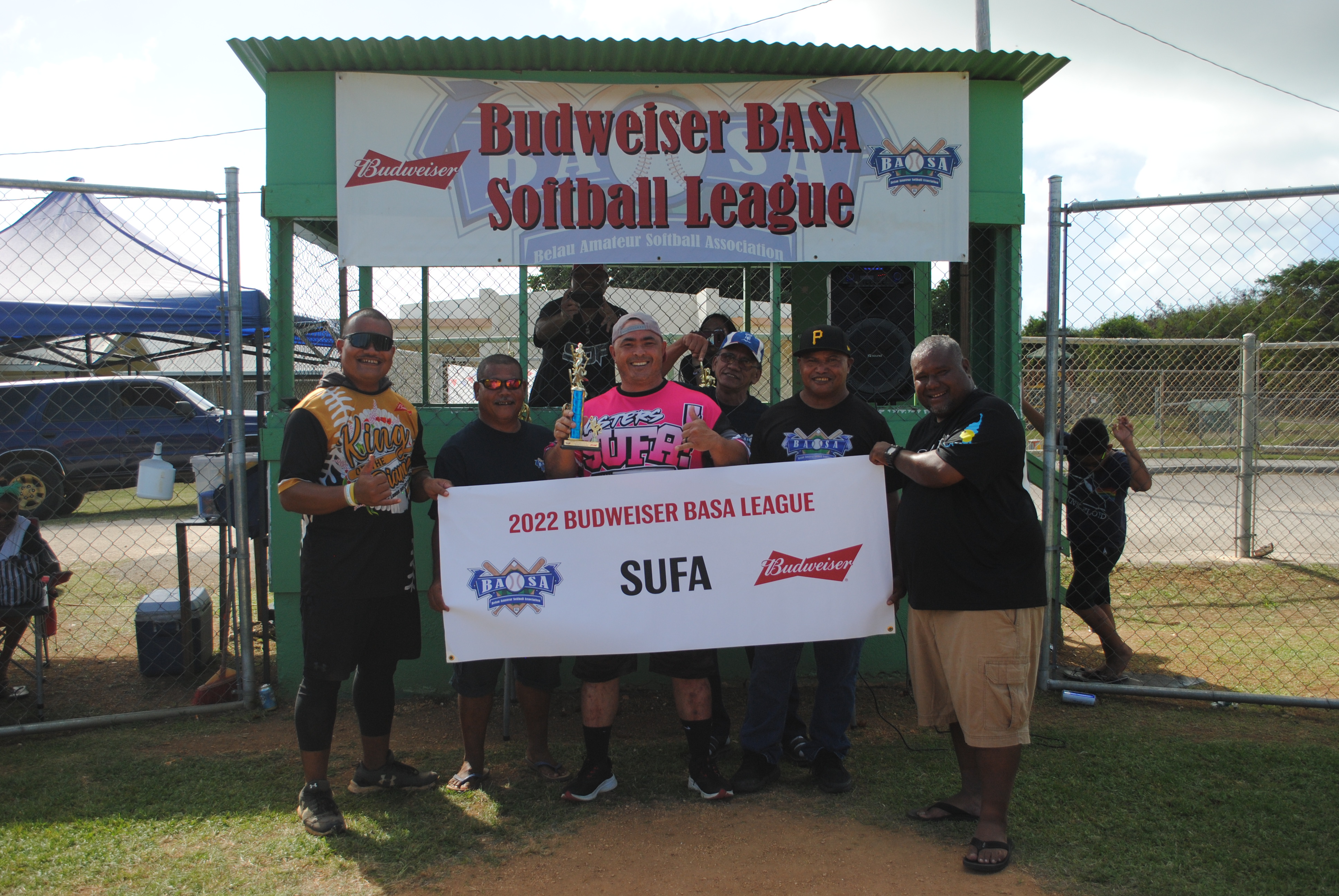 Audie Maratita, the men’s division regular season MVP, poses for a photo with Belau Amateur Softball Association officials at the Dandan baseball field on Sunday.