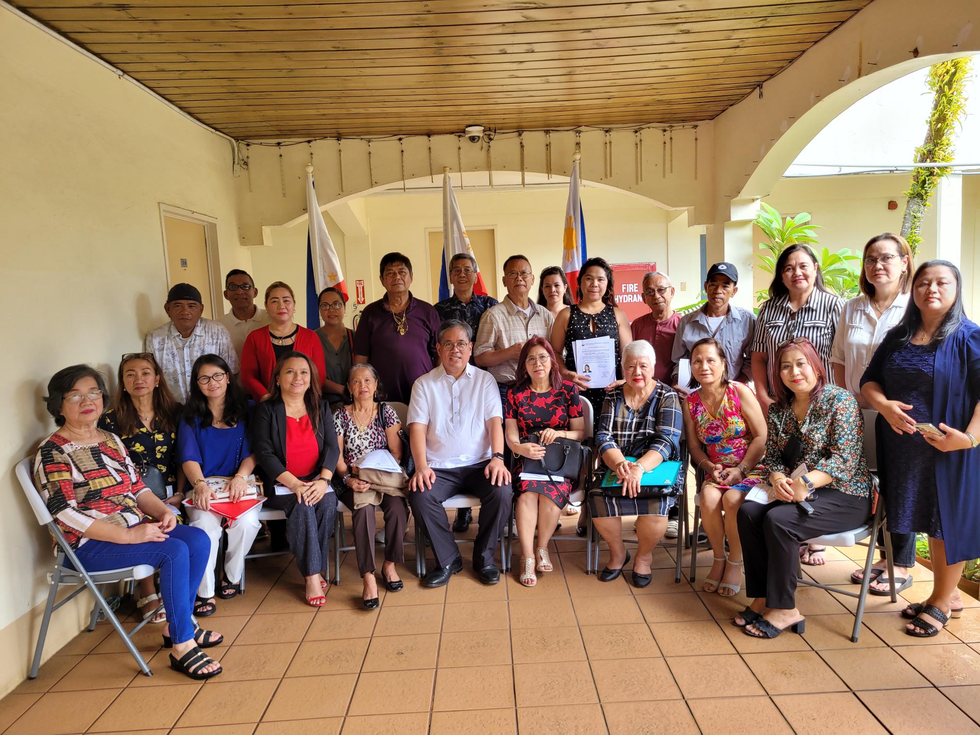 The Filipino-Americans who reacquired their Philippine citizenship pose for a photo with Philippine Consul General to Guam Patrick John U. Hilado at Sun Palace Hotel in Susupe.