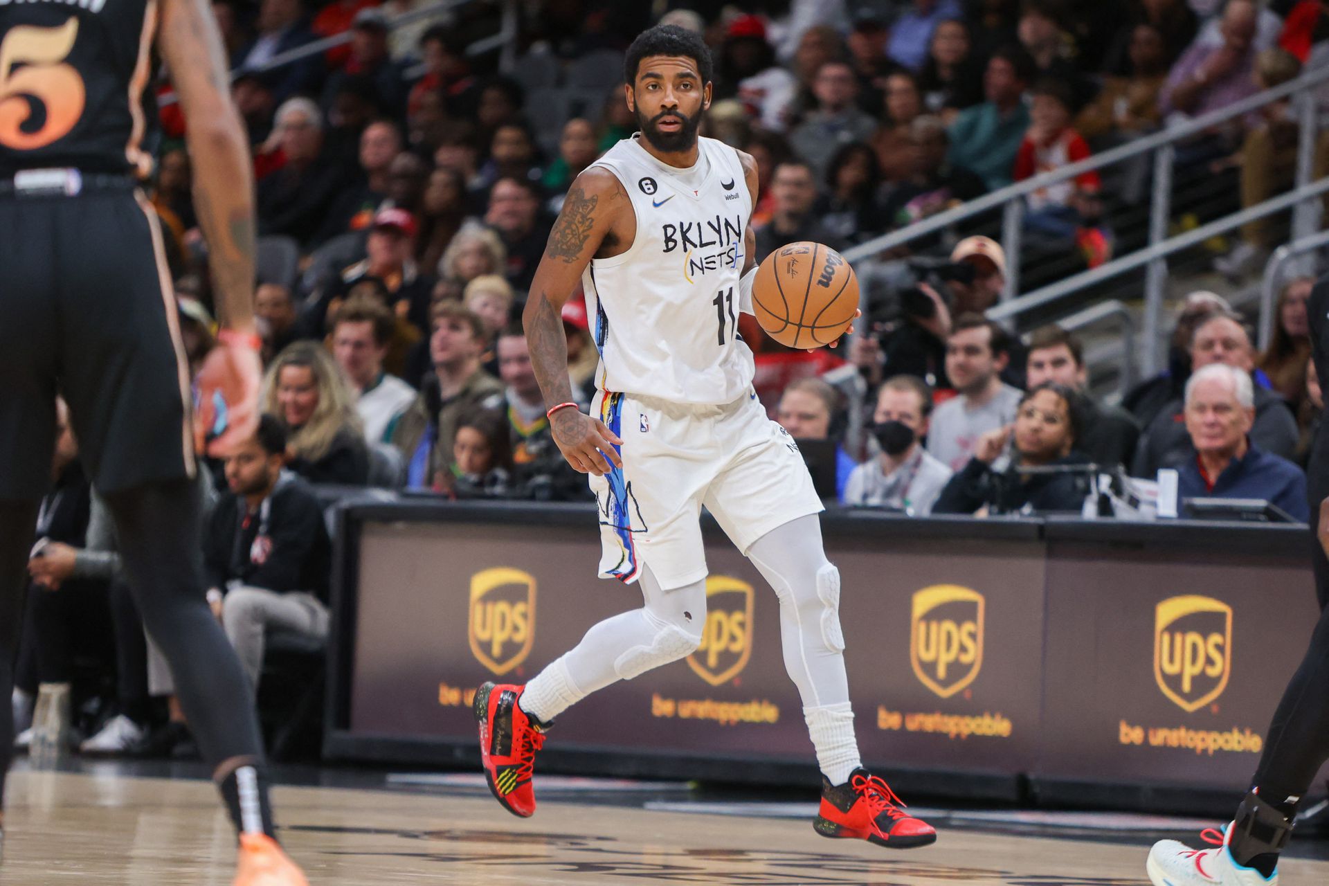Brooklyn Nets guard Kyrie Irving (11) dribbles against the Atlanta Hawks in the second quarter at State Farm Arena in Atlanta, Georgia, Dec. 28, 2022.