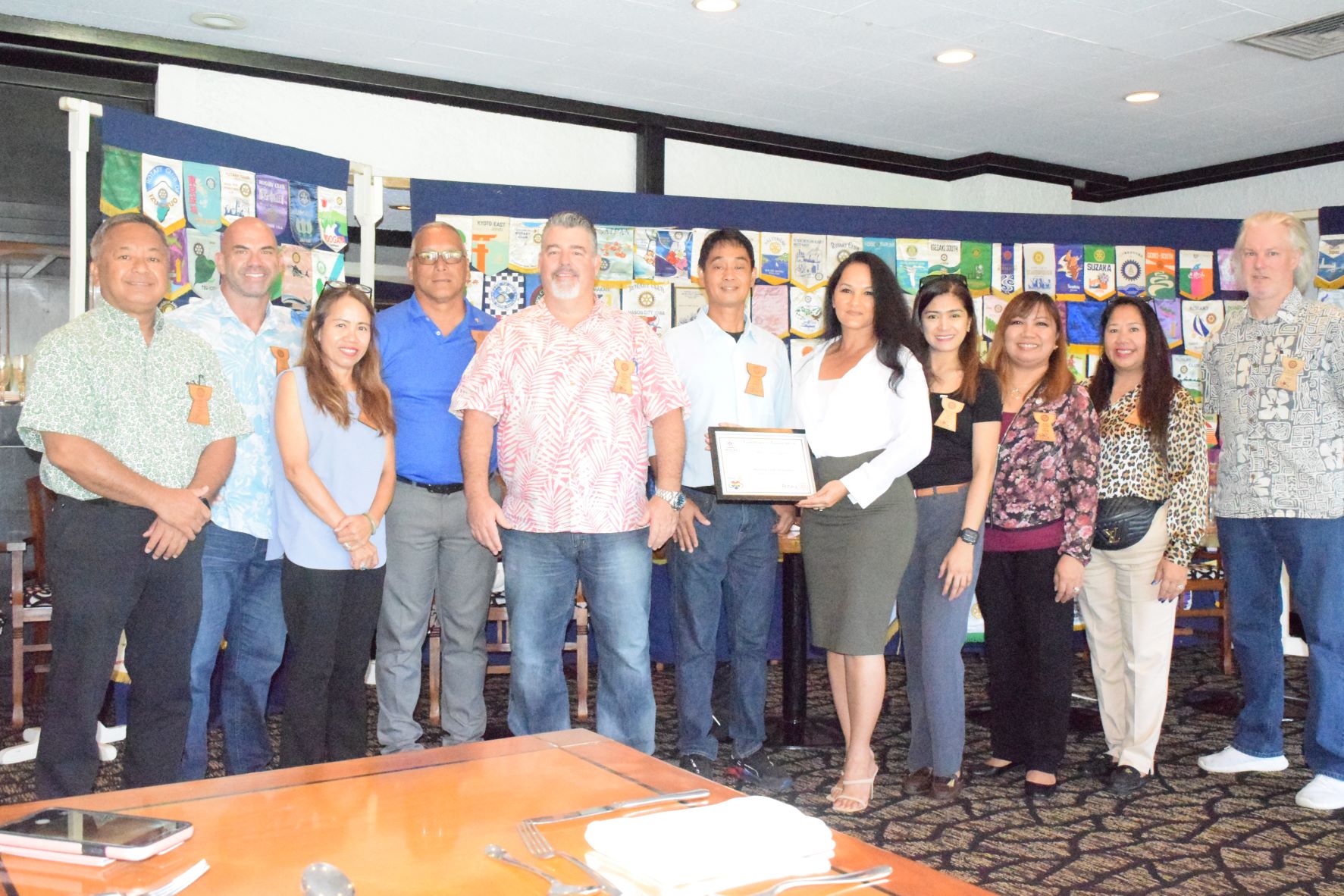 Rotary Club of Saipan President Wendell Posadas, center, hands a plaque of appreciation to guest speaker, CNMI Veteran Affairs Office Executive Officer Marie Salas-Igitol, on Tuesday at Hyatt Regency Saipan's Giovanni's Restaurant.
