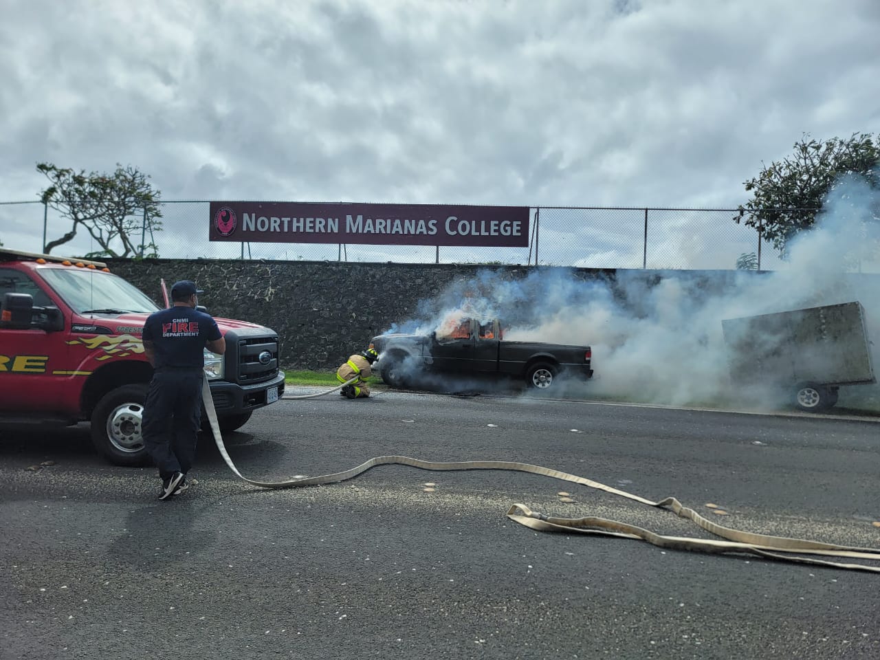 A firefighter aims a hose at a pickup truck on fire Saturday noon on As Terlaje Hill. No one was hurt.
