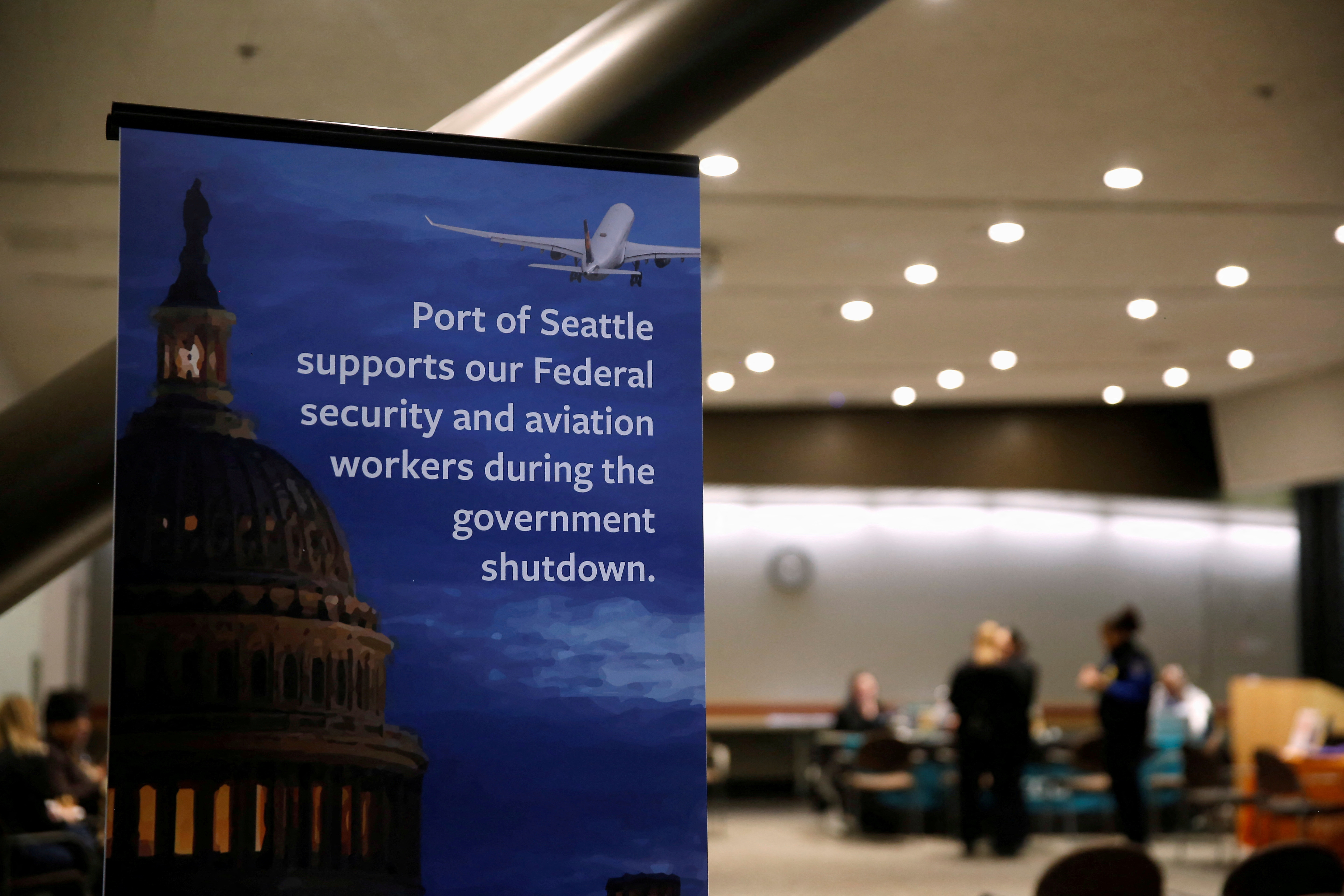 A Port of Seattle sign referencing the shutdown sits outside a resource fair for employees affected by the partial federal government shutdown at Seattle-Tacoma International Airport in Seattle, Washington on Jan. 14, 2019.
