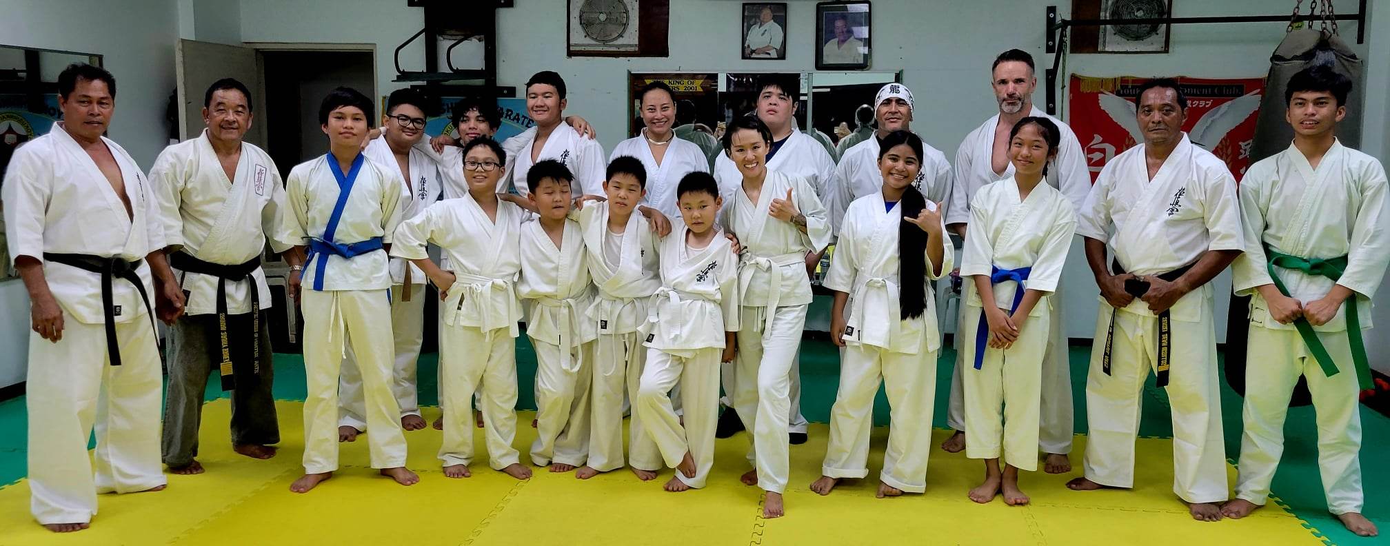 Adult and youth students pose for a photo during the Kyokushin Karate Dojo Examination and Belt Promotion under Sensei Danny Banez.