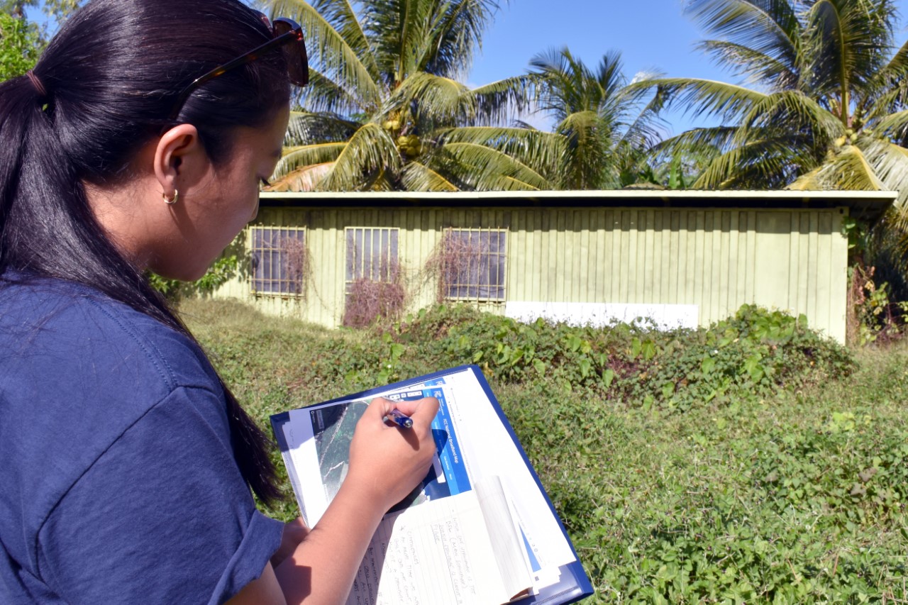 Nami Mafnas, program consultant for the Office of Planning and Development, surveys broadband serviceable locations for the CNMI Broadband Project.