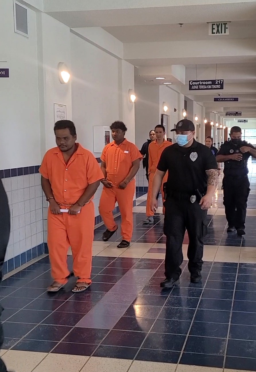 Rickson Michael and Julius Paul are escorted by Corrections officers at Guma Hustisia.