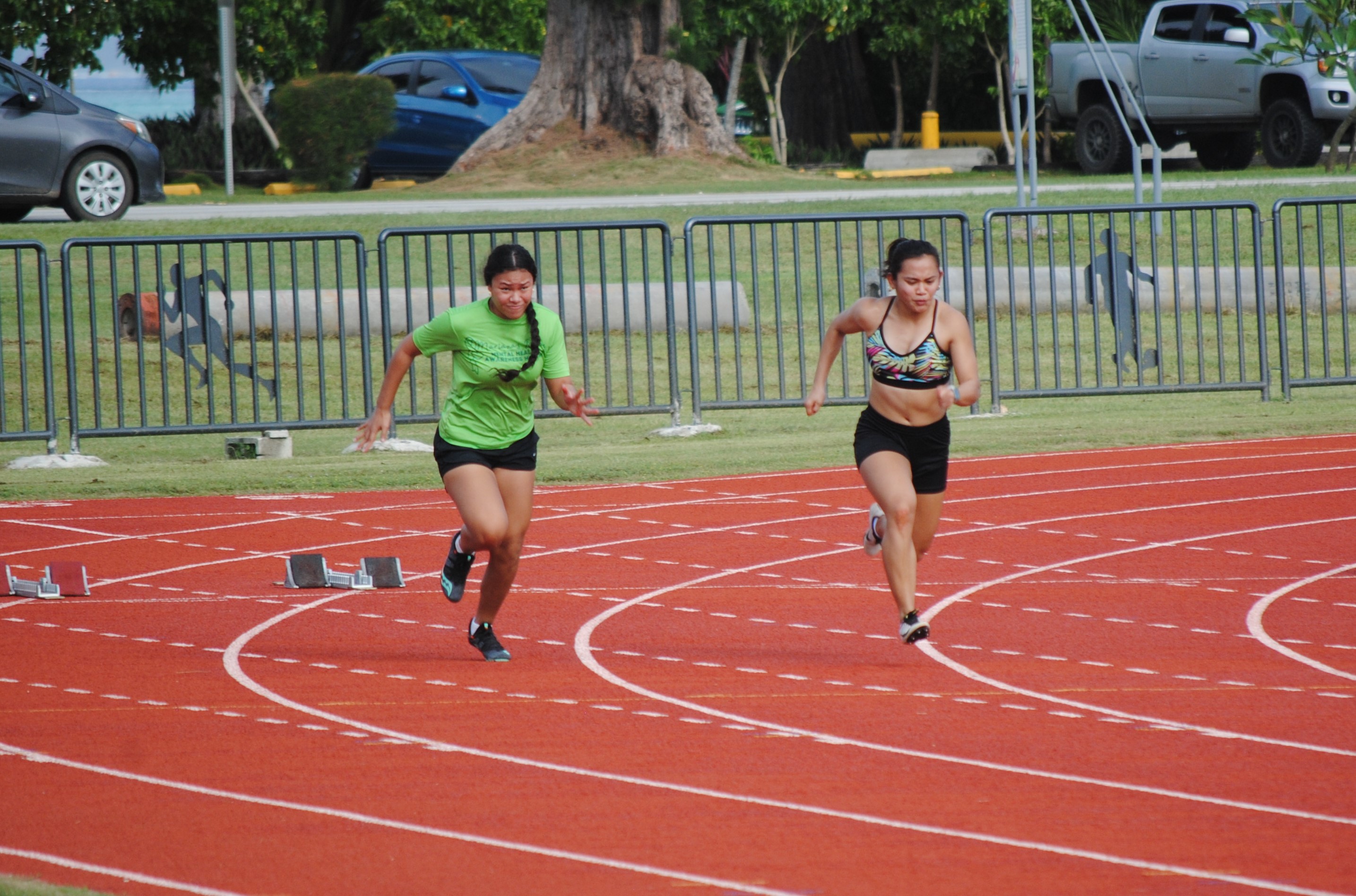 Maria Igitol and Zarinae Sapong push through the starting point of the 100m event during the NMA Track & Field Challenge on Saturday at the Oleai Sports Complex.