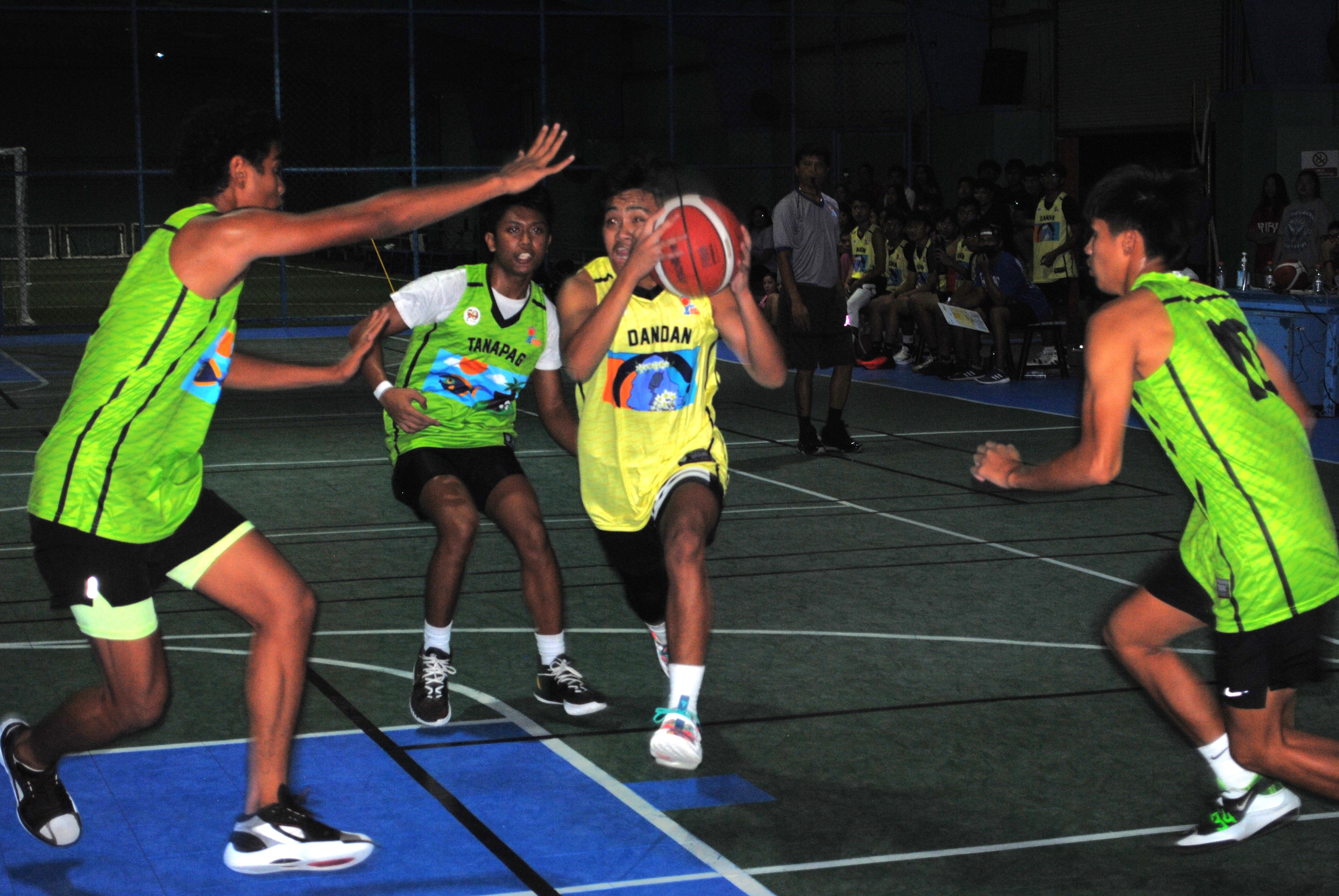 Dandan's Gabriel Arkoh protects the ball as he drives in for the finish during a U18 boys division game of the 2022 Marianas Village Pride Basketball League at the TSL Sports Complex.