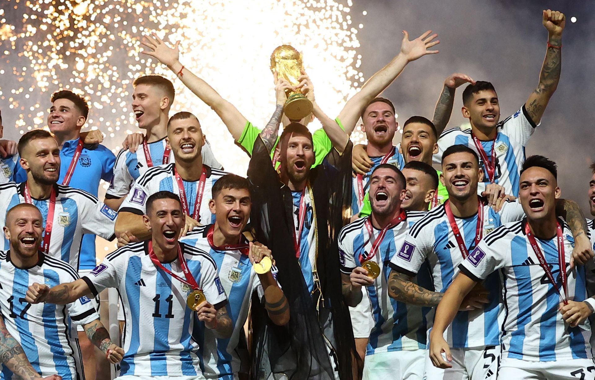 Argentina's Lionel Messi lifts the World Cup trophy alongside teammates as they celebrate after winning the World Cup at Lusail Stadium in Lusail, Qatar on Dec. 18, 2022