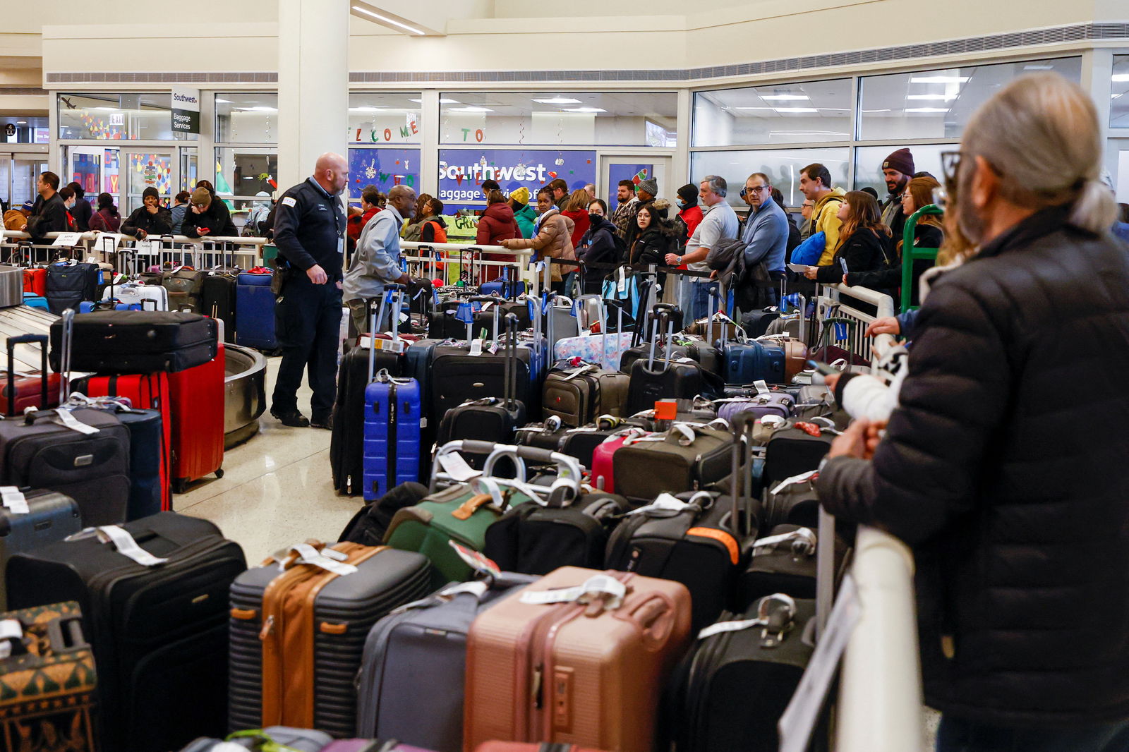Southwest Airlines travelers wait in line to check on their baggage from their canceled flights after an arctic blast and a massive winter storm dubbed Elliott swept over much of the United States in the lead-up to the Christmas holiday weekend, at Chicago Midway International Airport in Chicago, Illinois, Dec. 27, 2022.