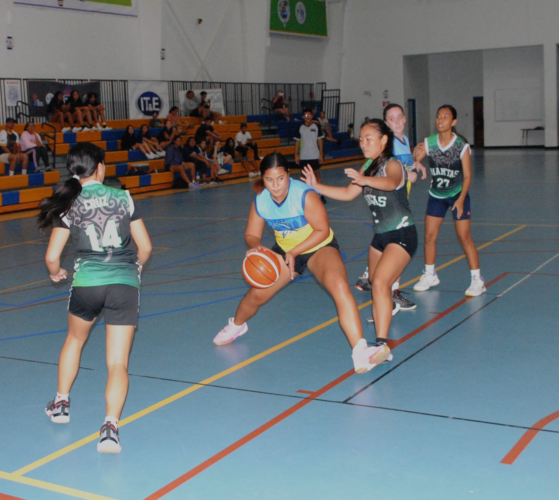 MHS' Angellyn Roligat steps in between two defenders to finish the shot during the championship game against SSHS in the girls high school division of the IT&E Interscholastic Basketball League on Saturday at MHS gym.