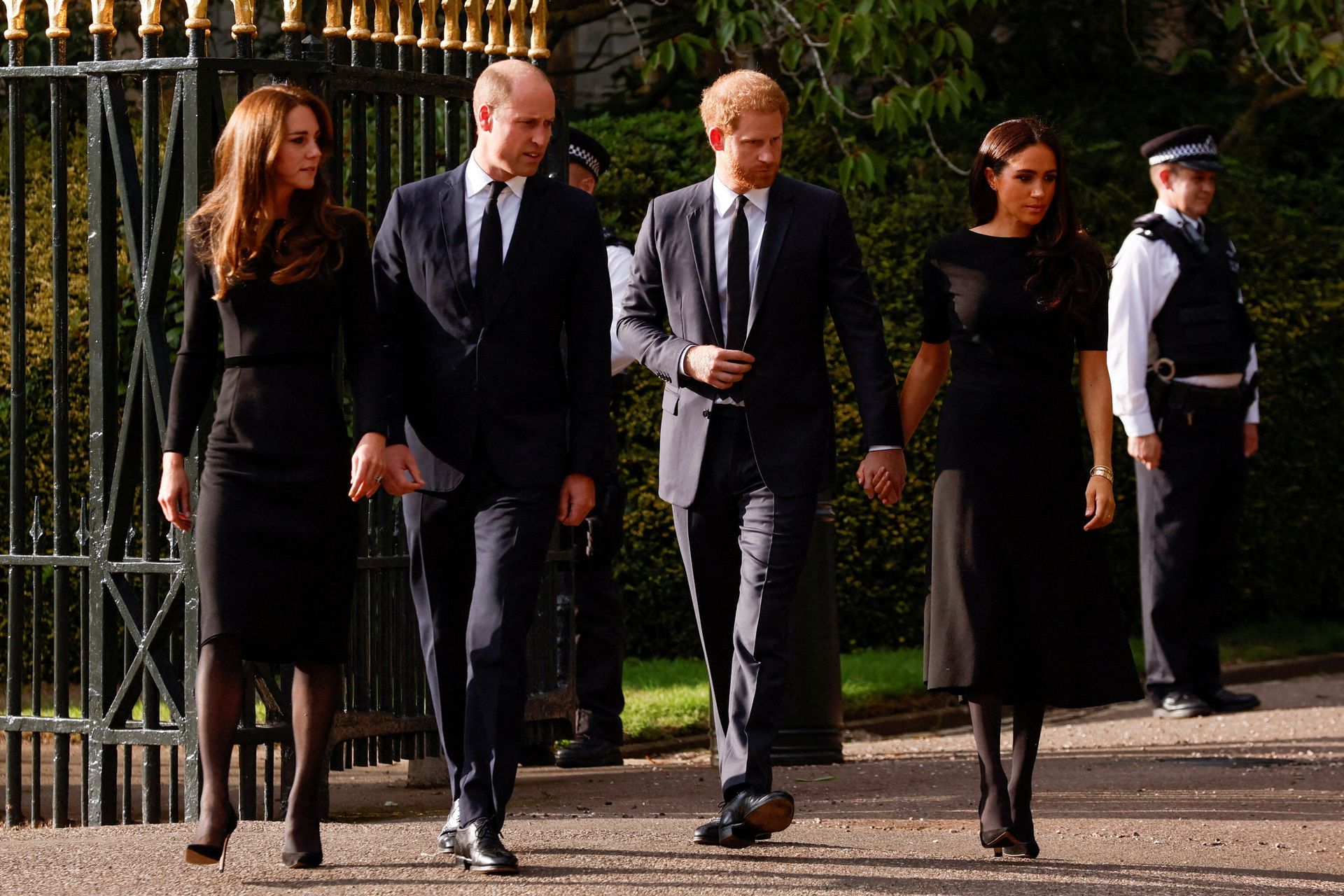 Britain's William, Prince of Wales, Catherine, Princess of Wales, Britain's Prince Harry and Meghan, the Duchess of Sussex, walk outside Windsor Castle, following the passing of Britain's Queen Elizabeth, in Windsor, Britain, Sept. 10, 2022.