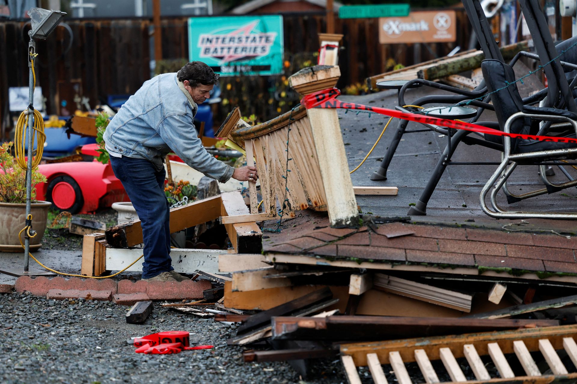 Homeowner Darren Gallagher inspects the collapsed second story porch of his house after a strong 6.4-magnitude earthquake struck off the coast of northern California, in Rio Dell, California, Dec. 20, 2022.